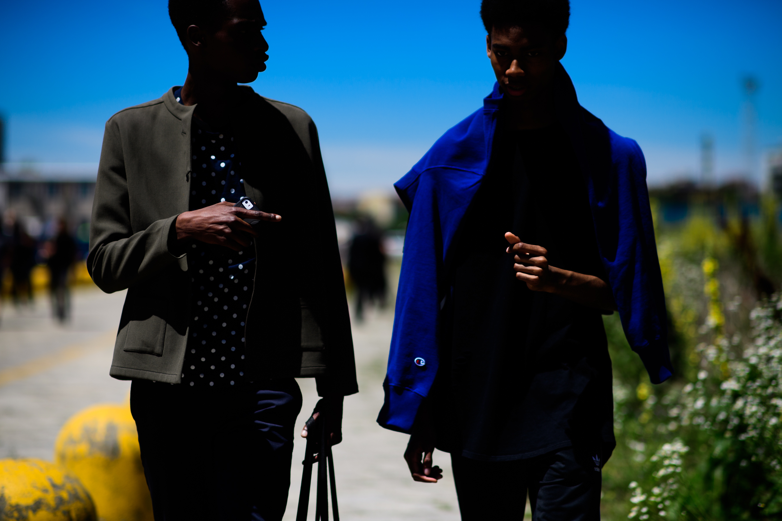 Two men wearing khaki green and blue