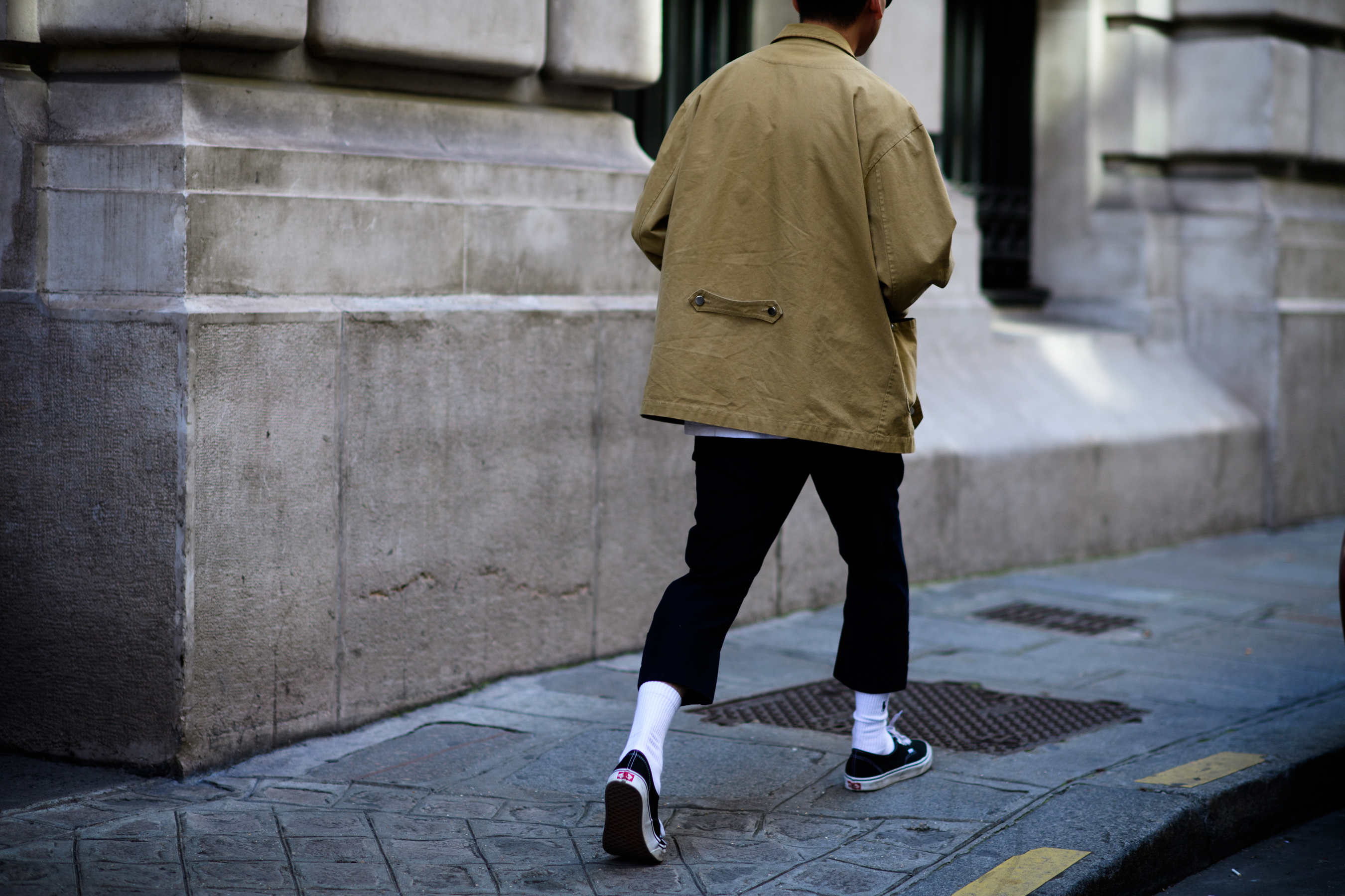 A man wearing a beige jacket