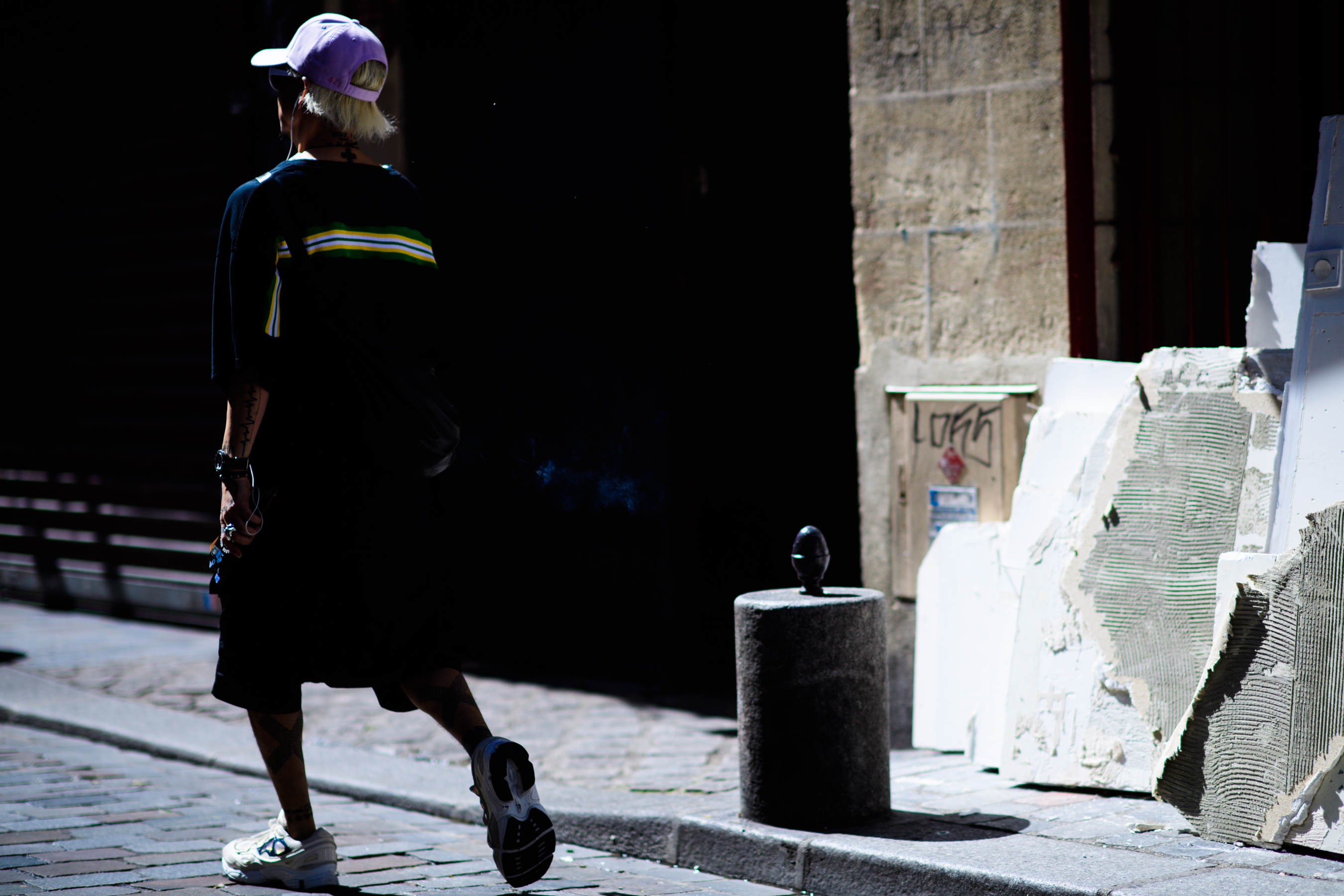 Man in sneakers, purple hat