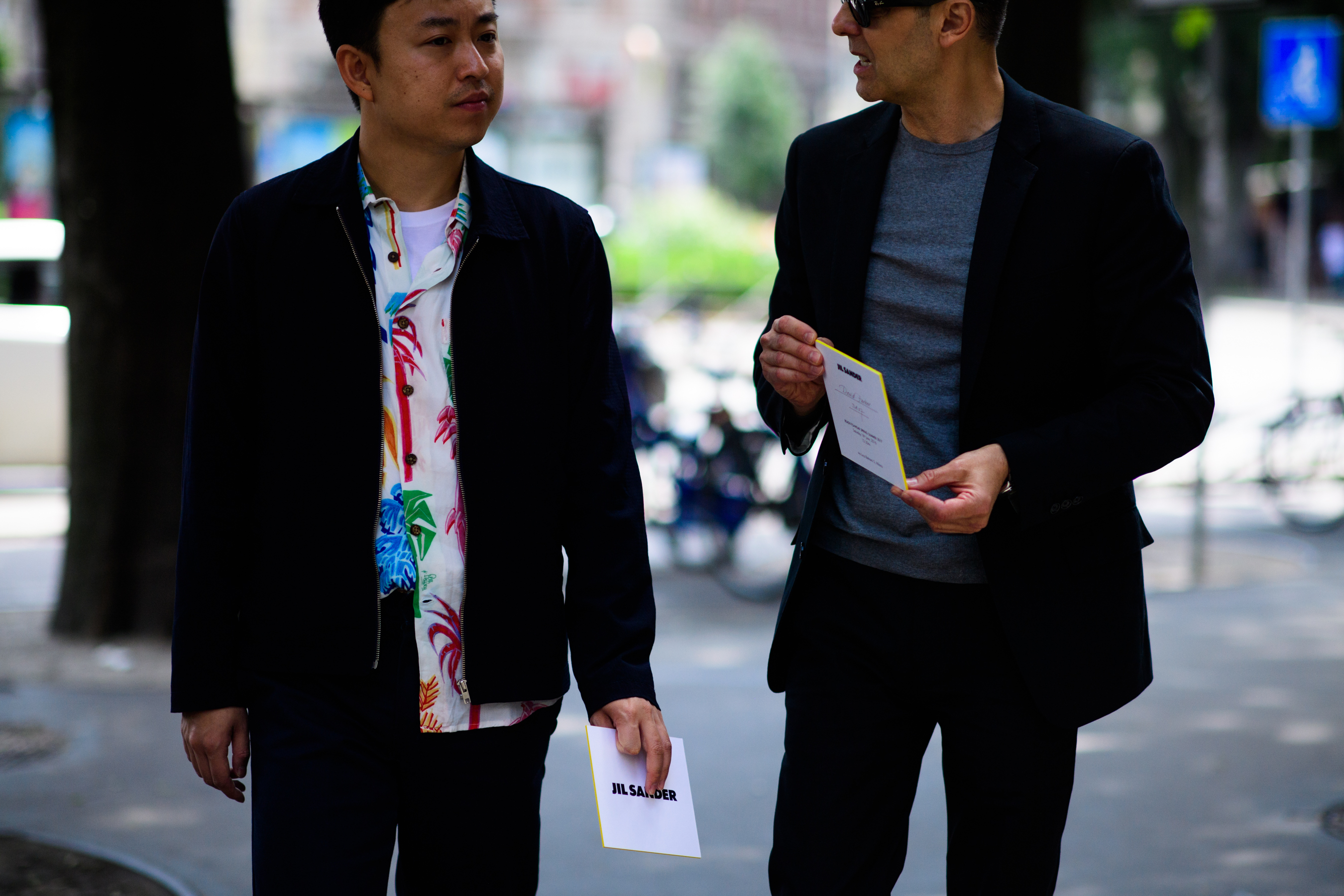 Two men wearing dark blue suits