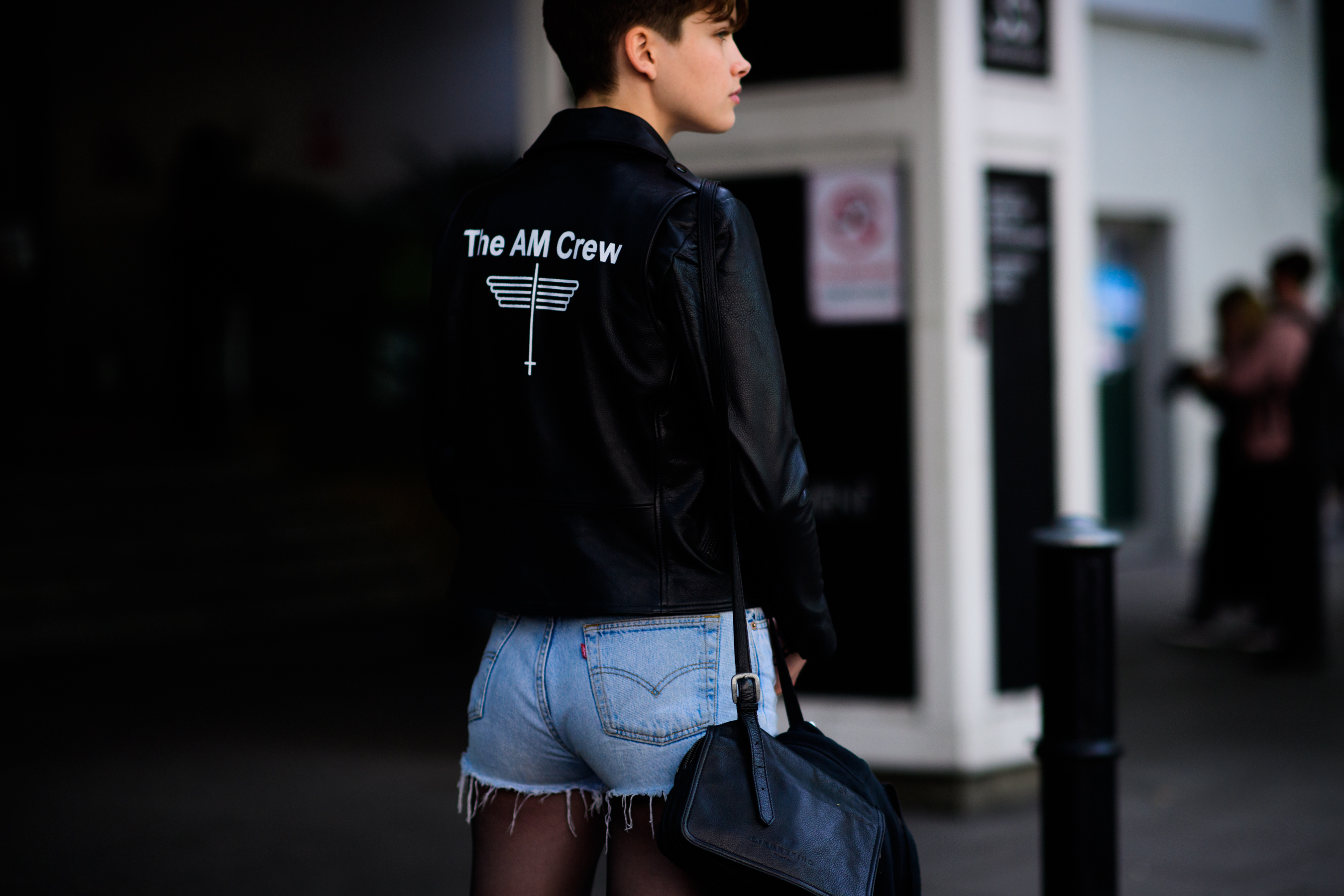 Model wearing leather jacket, shorts