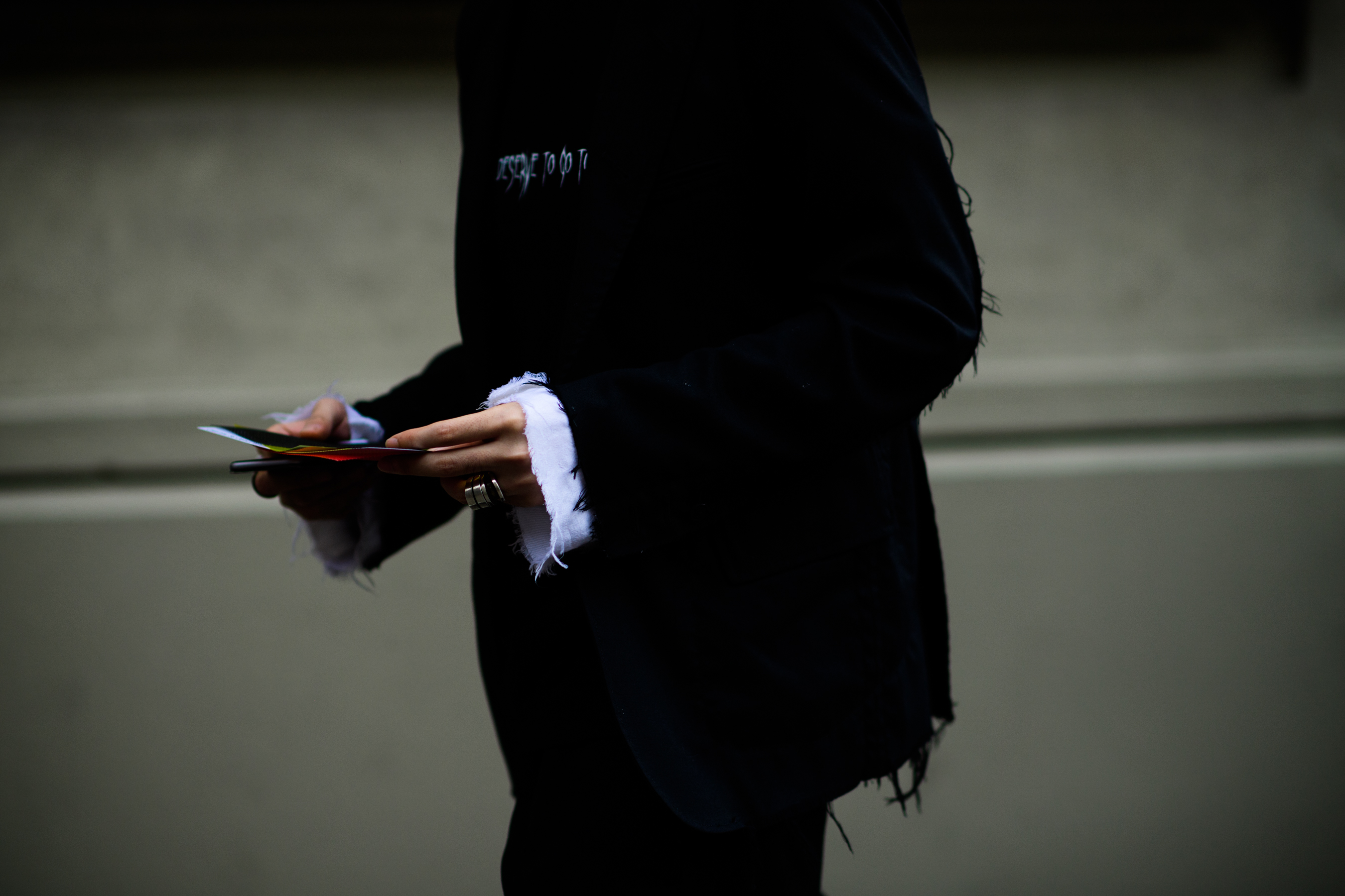 Black jacket worn over white shirt