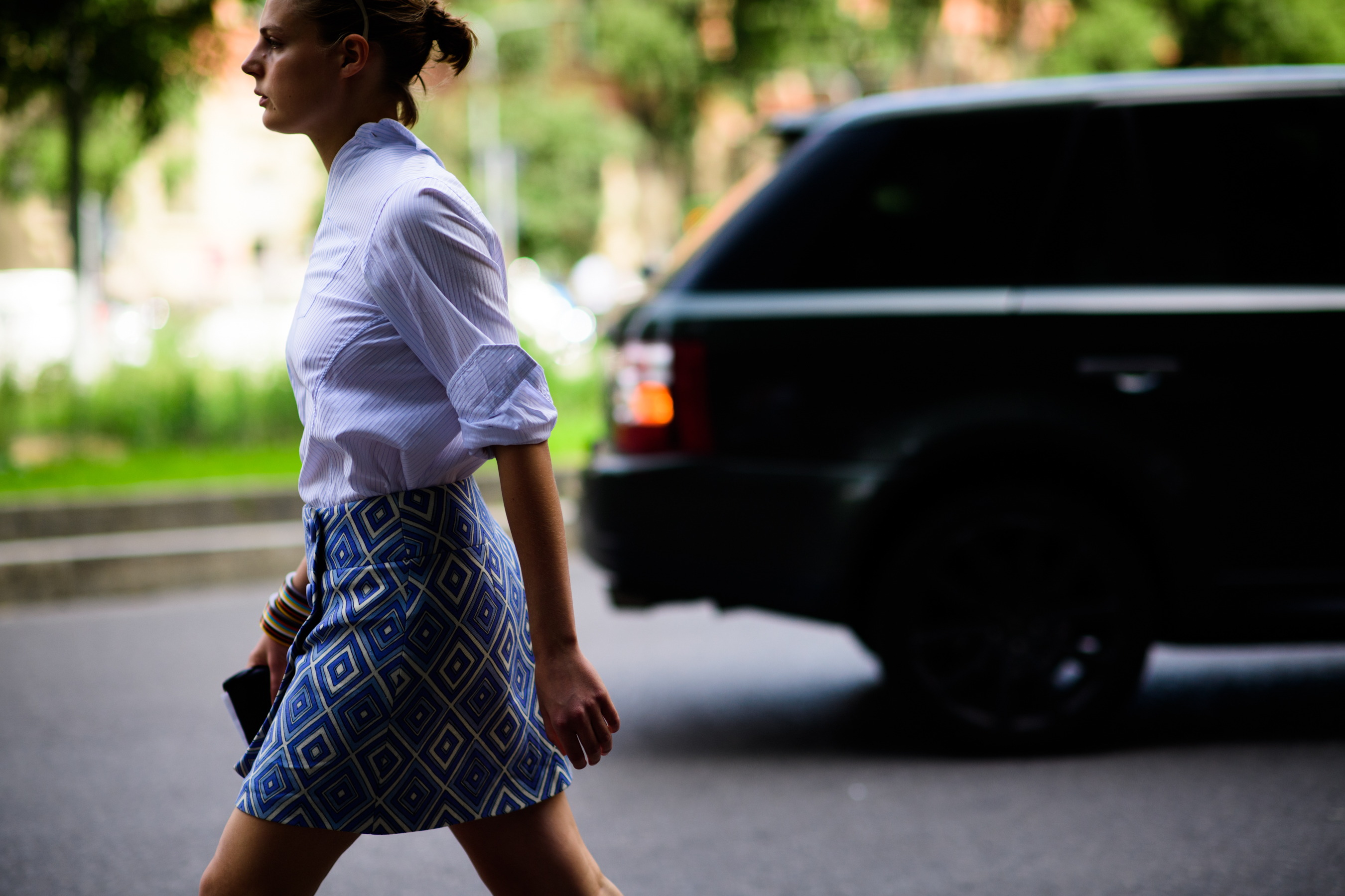 A woman in a blouse and a blue skirt