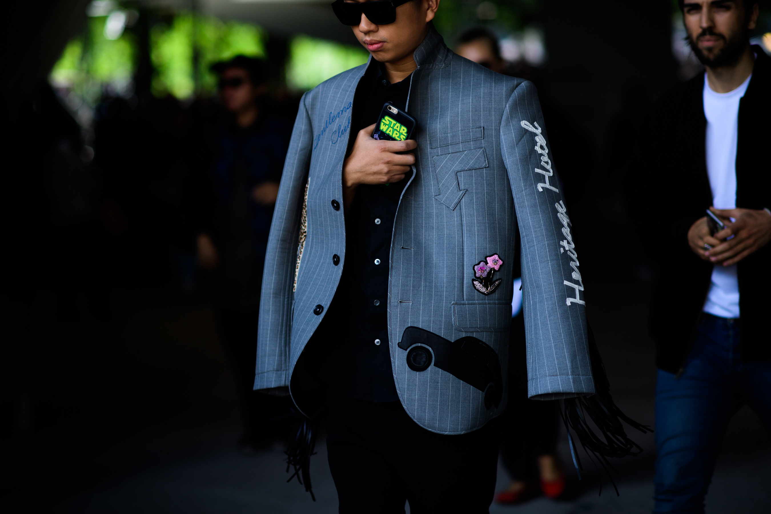 Man in grey jacket with patches