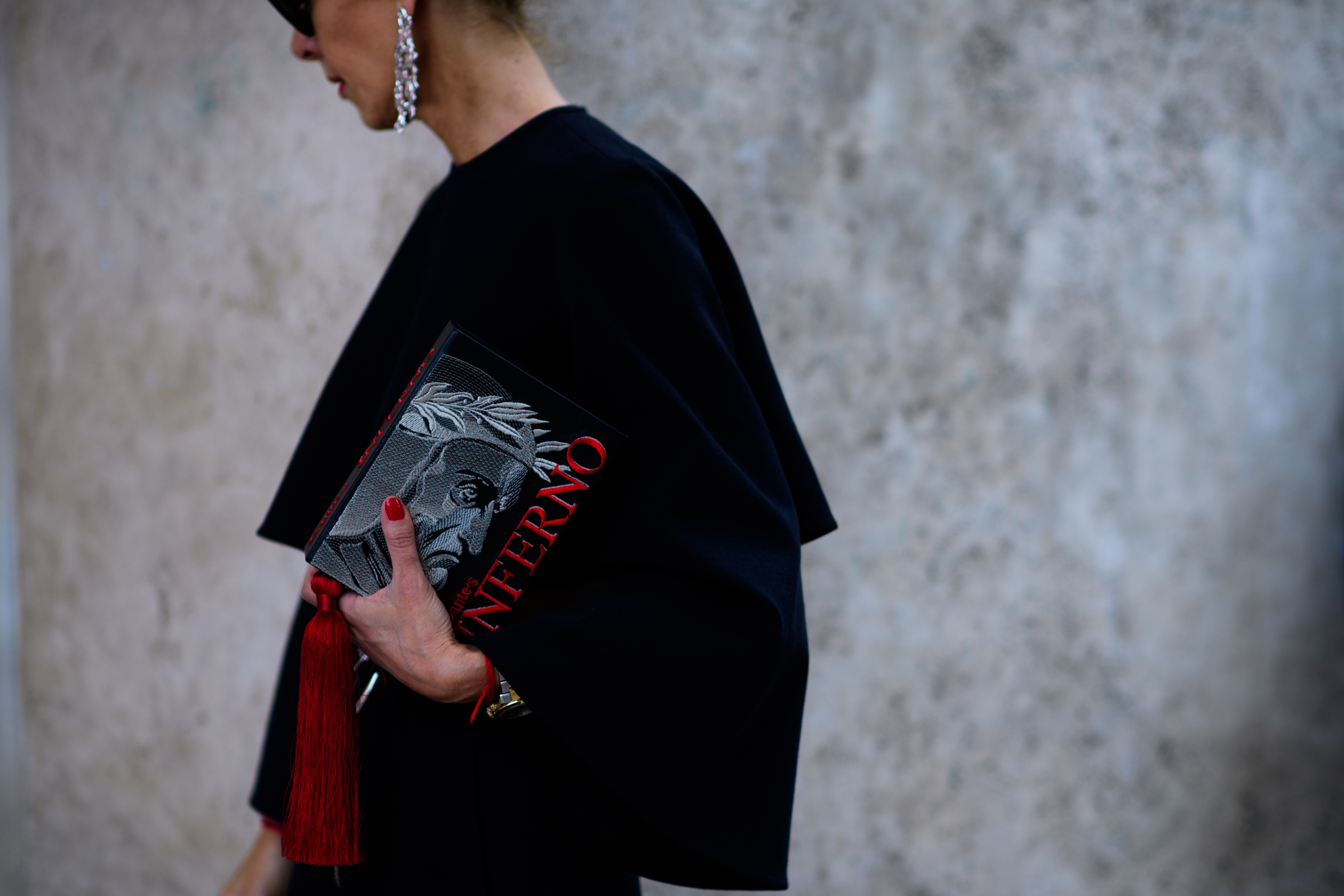 A woman in black holding a bag