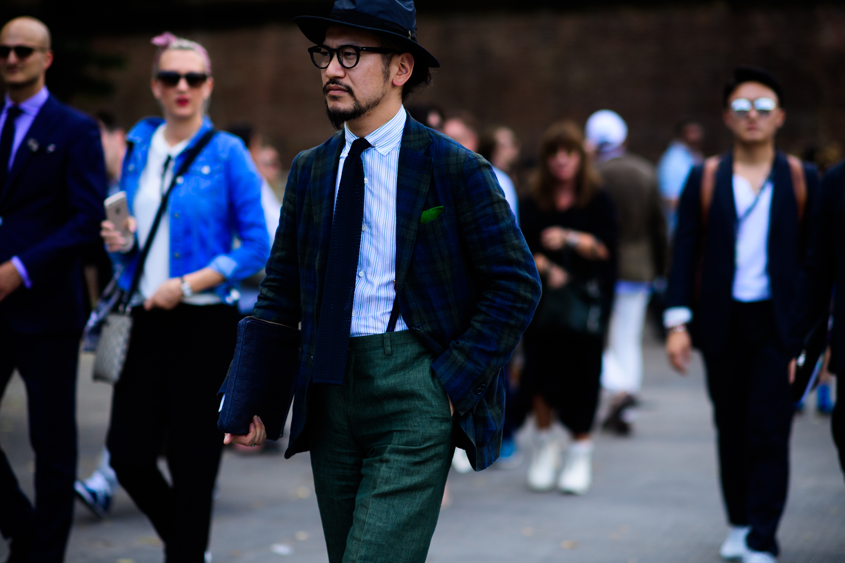 An Asian man in green trousers