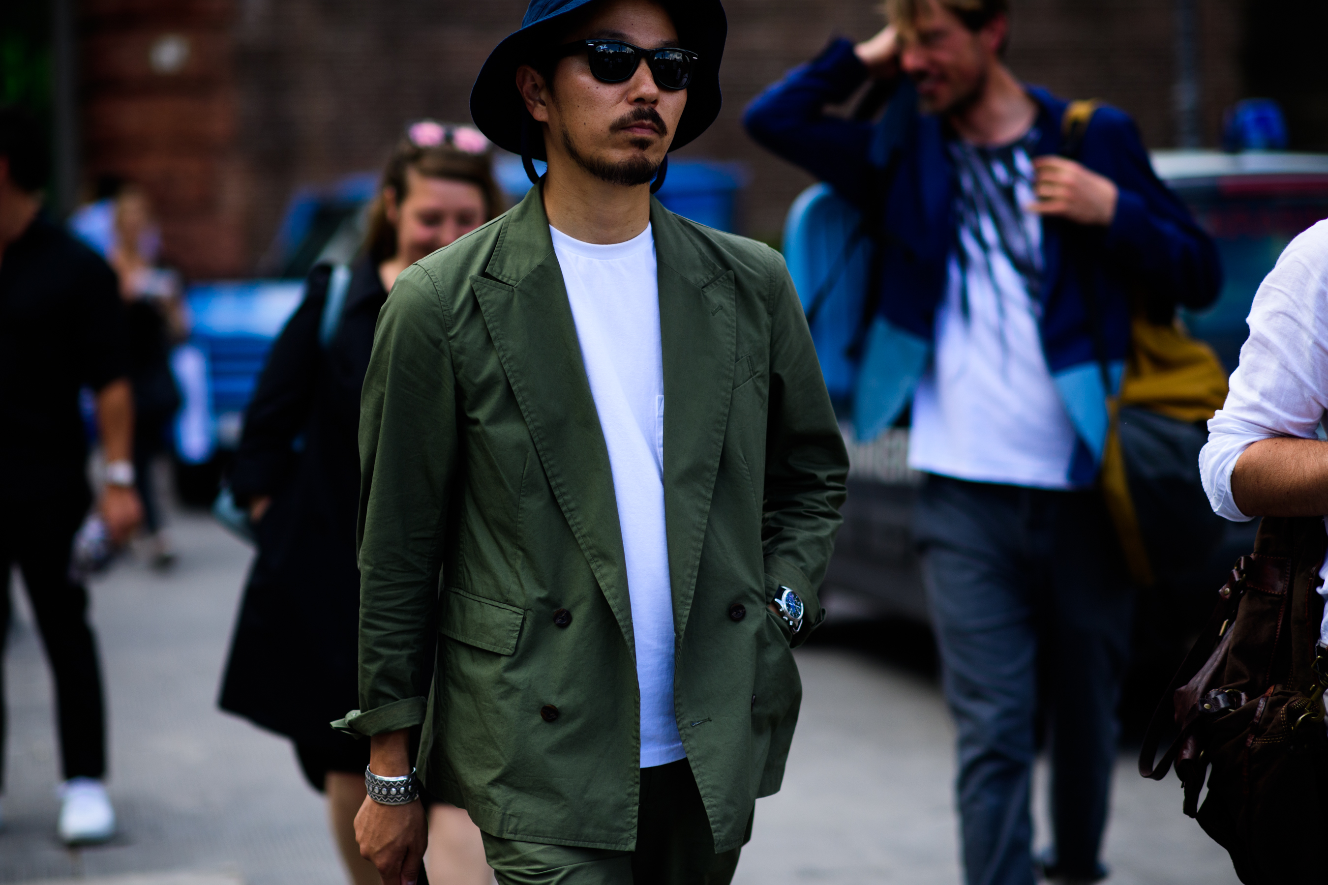 A man in a green jacket, a hat