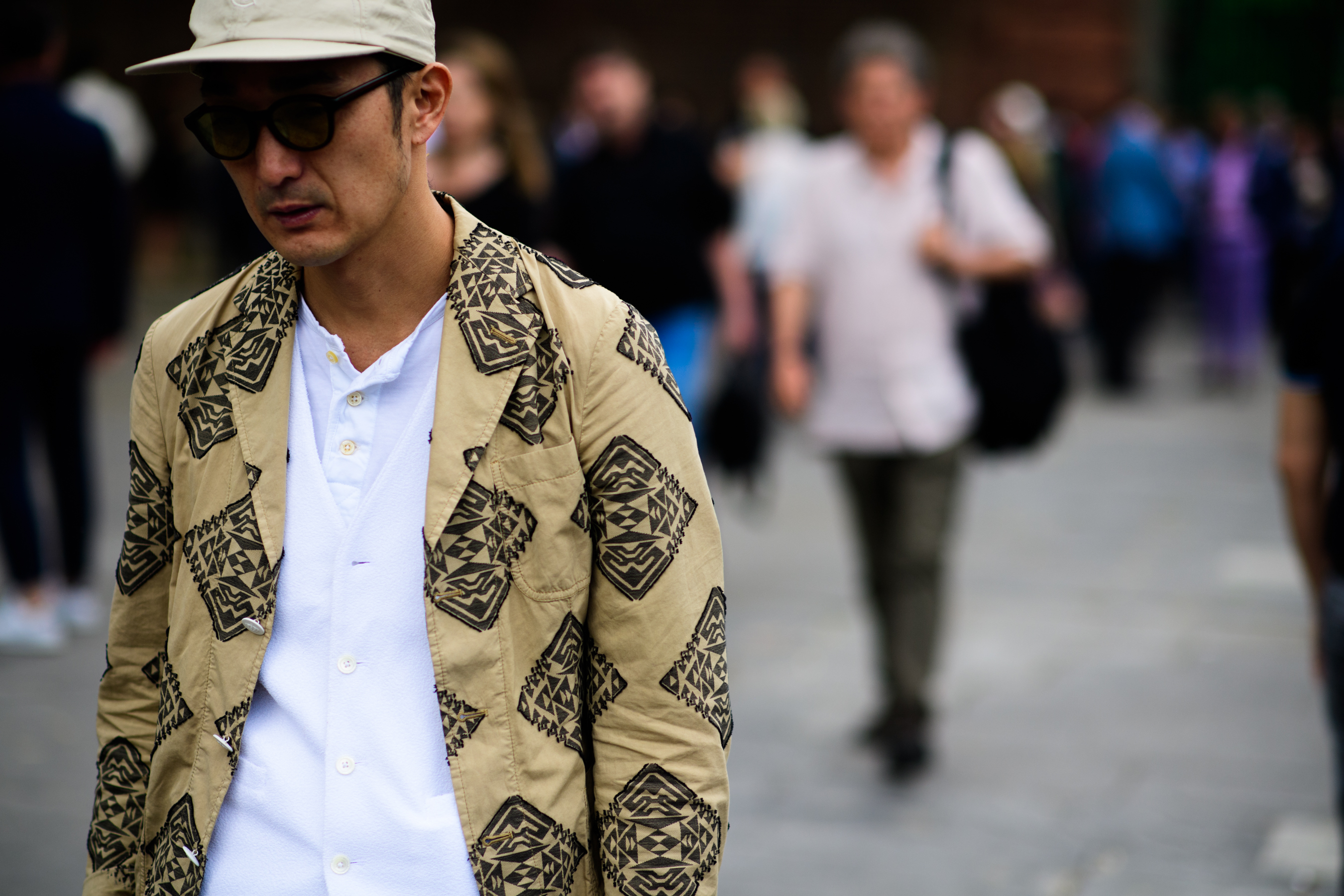A man in a hat and a beige jacket