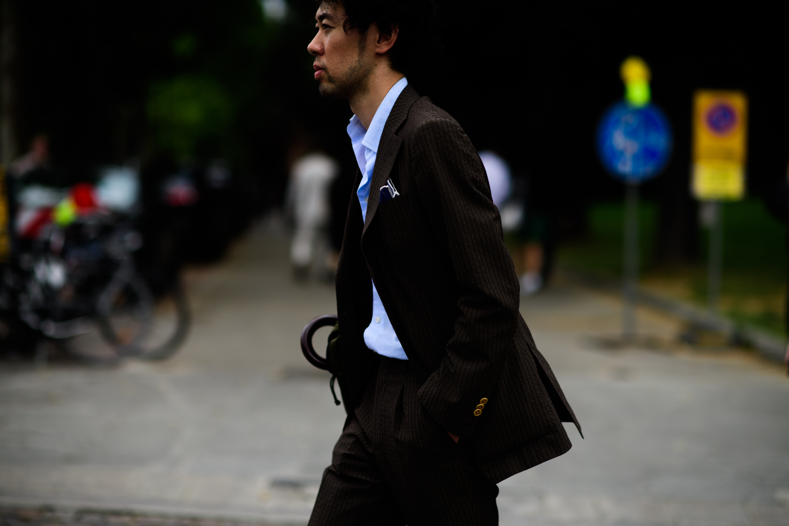 Young Asian man in a brown suit