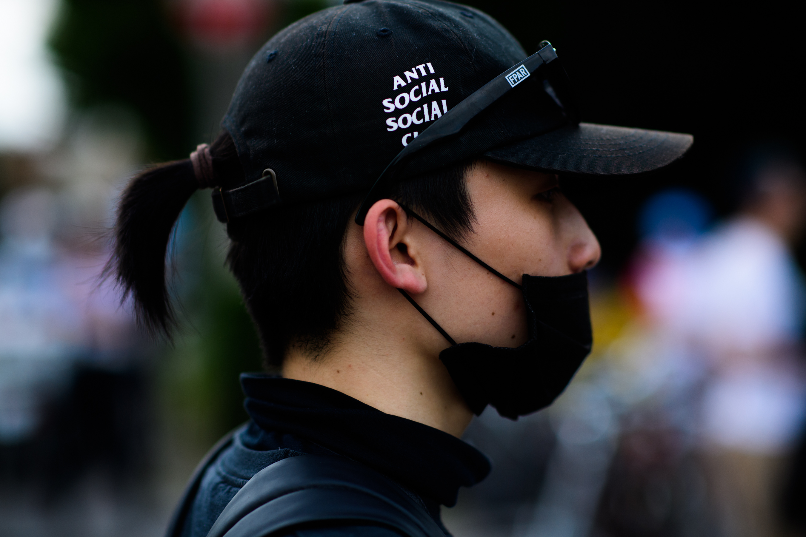 A girl in a black hat with a logo