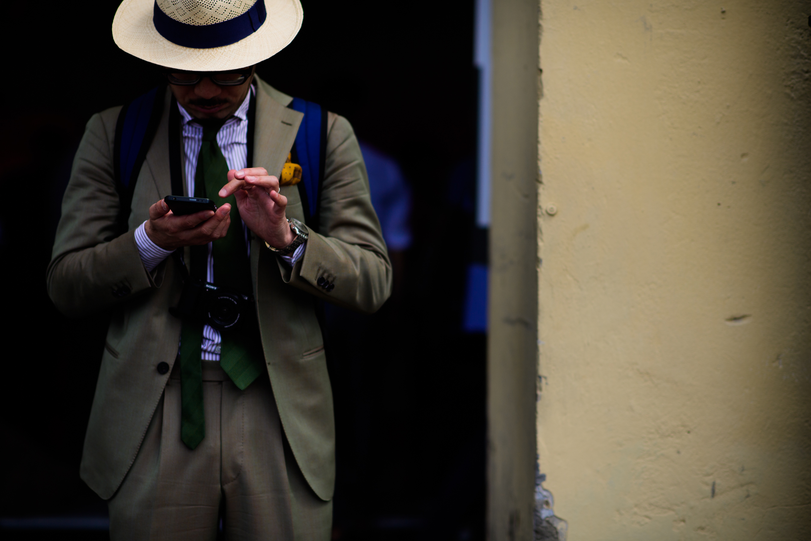 A man in a beige suit and a hat