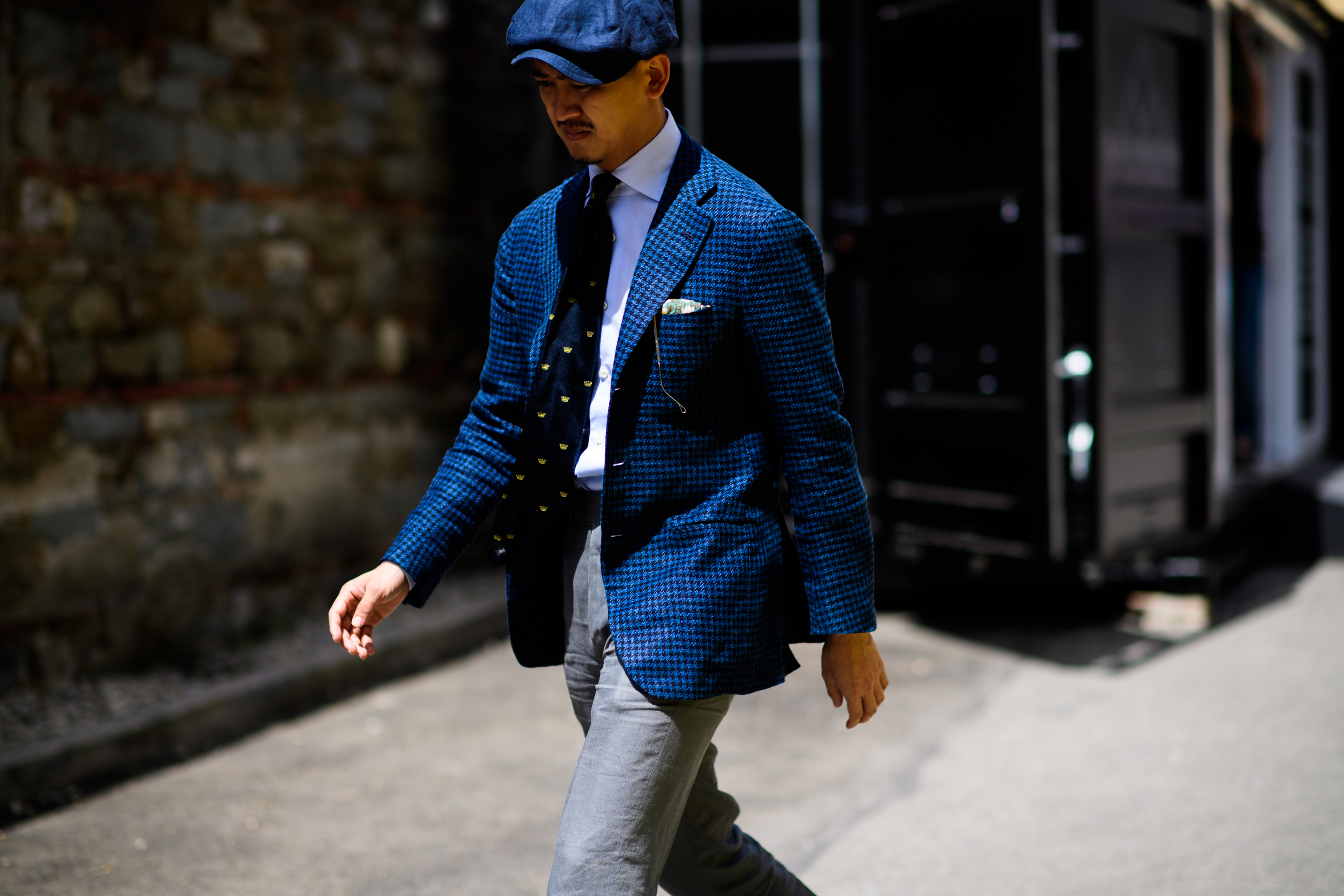 A man in a blue jacket and a hat