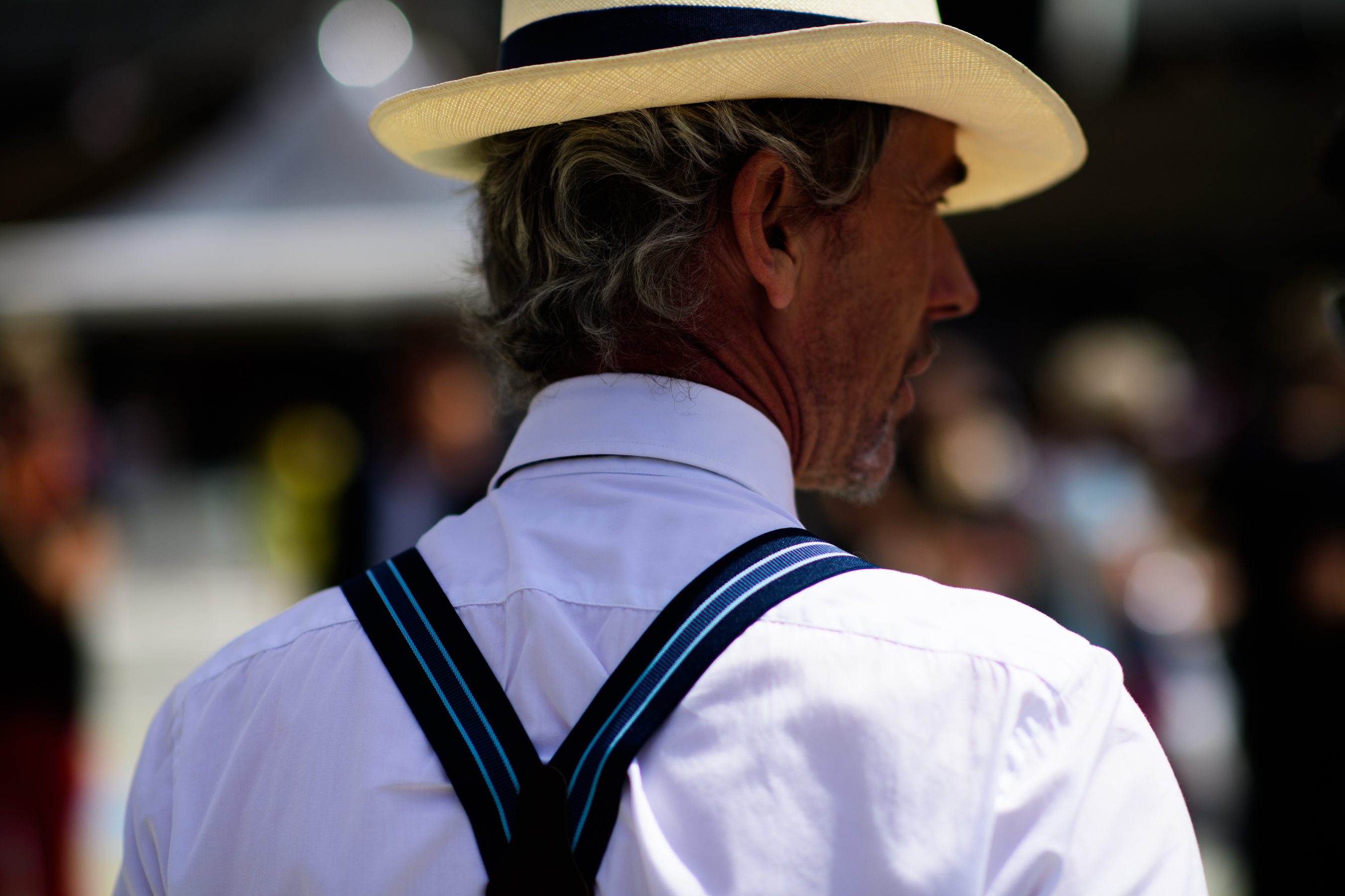 A man in a hat and suspenders