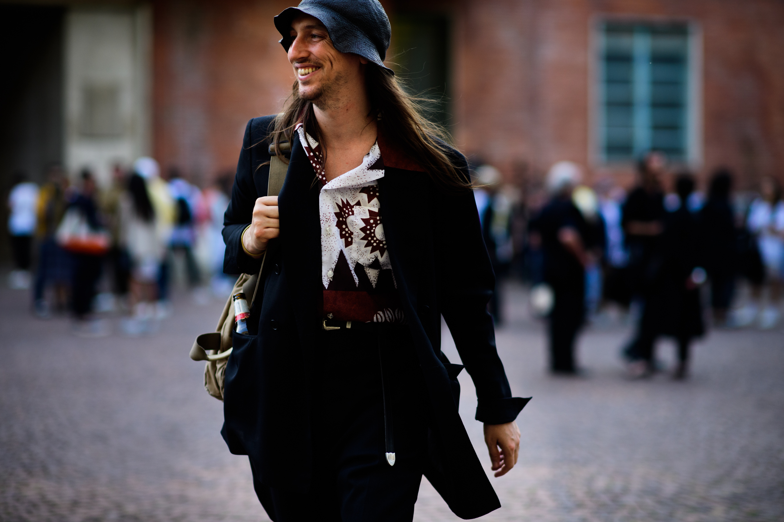 A man in a printed shirt, a hat