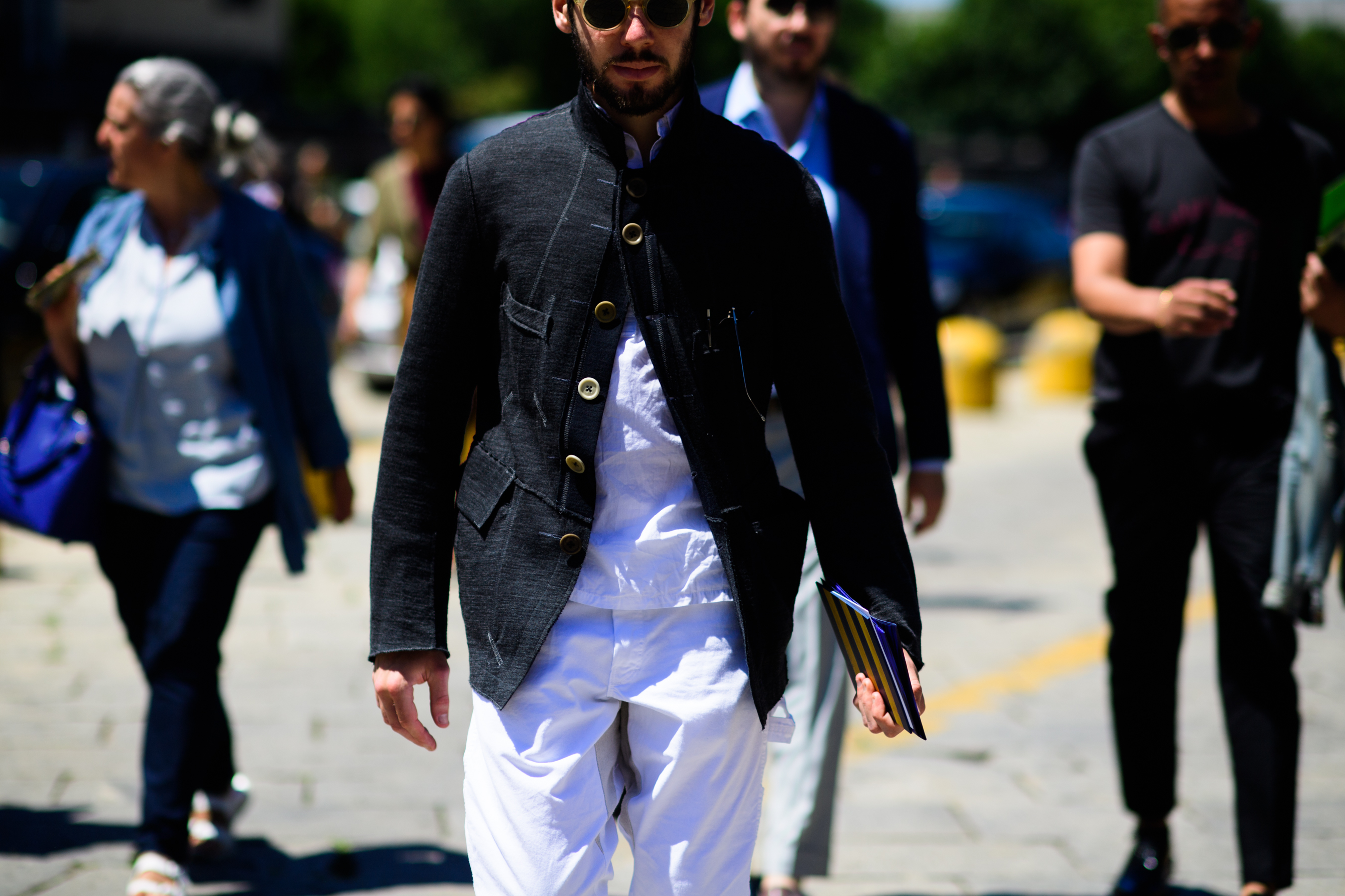 A man in white trousers and a black jacket