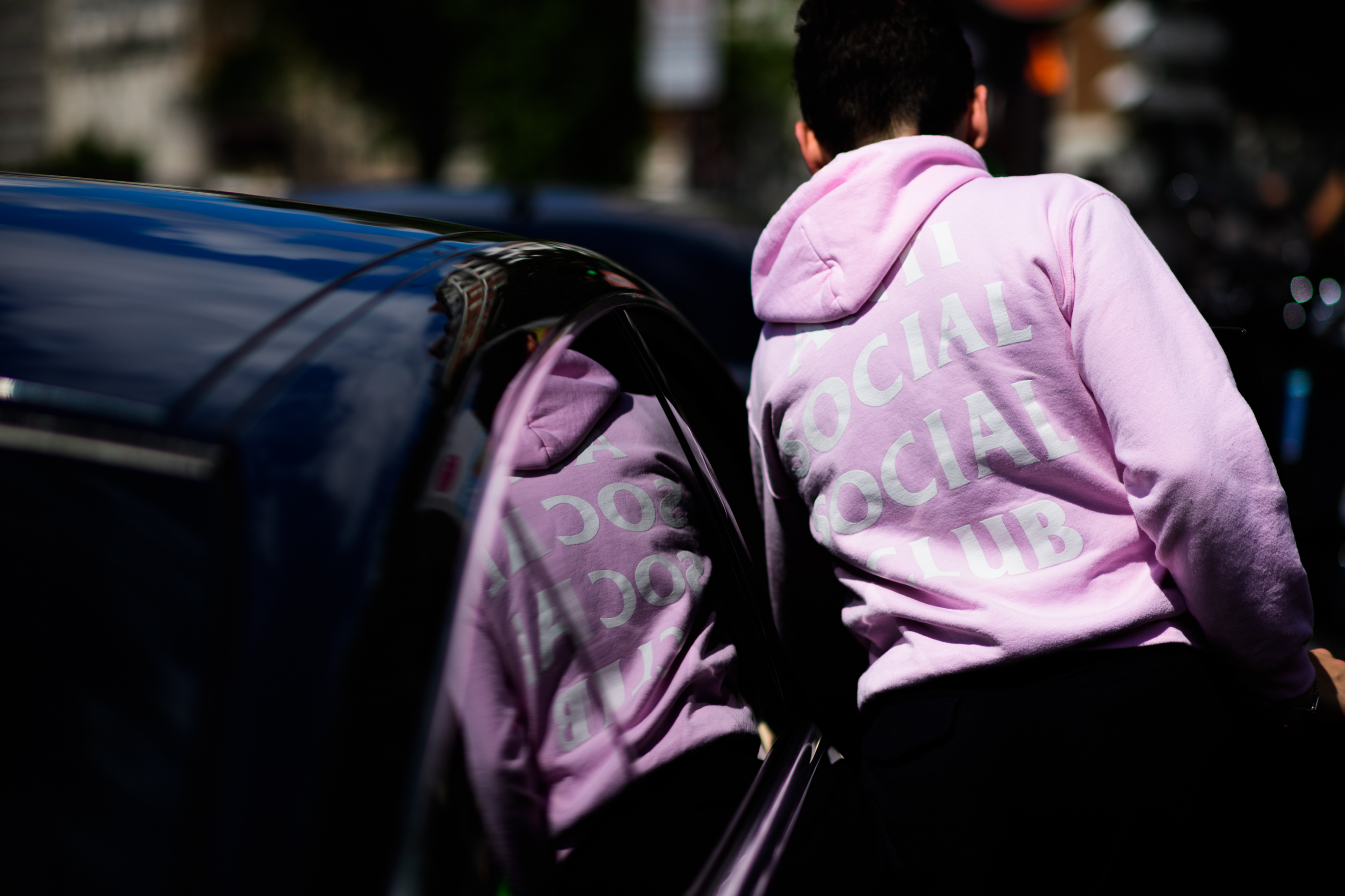 Man in pastel pink sweatshirt