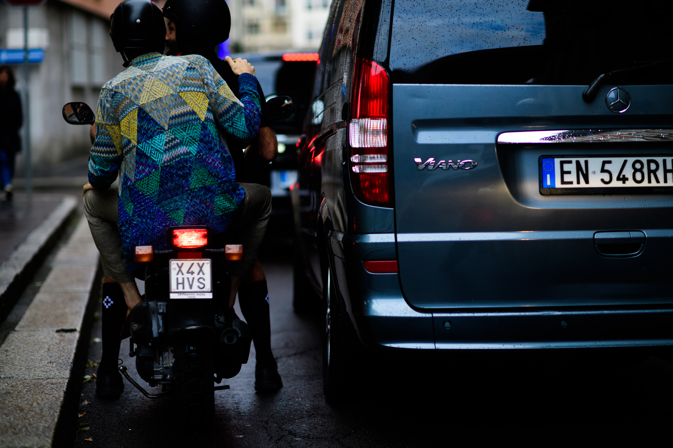 Men in printed clothes leaving on a bike