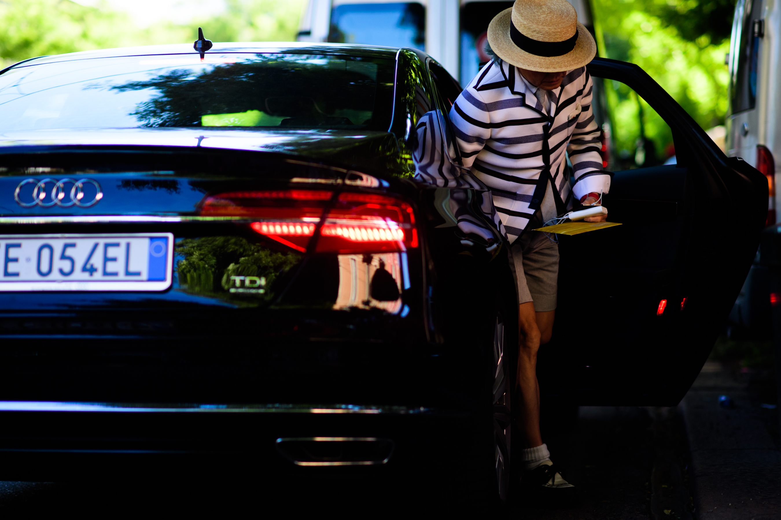 A man in a striped jacket, a hat