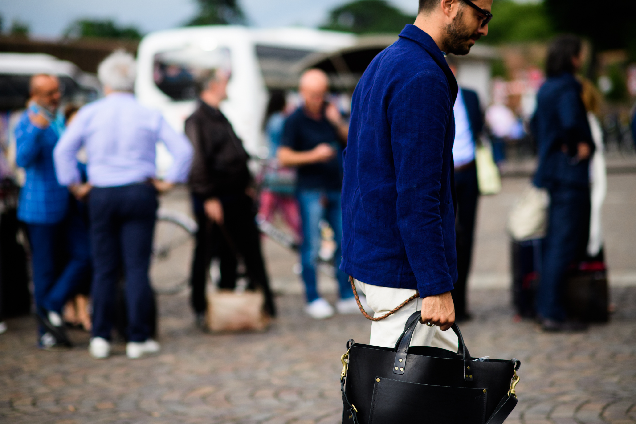 A man in a blue jacket with a bag