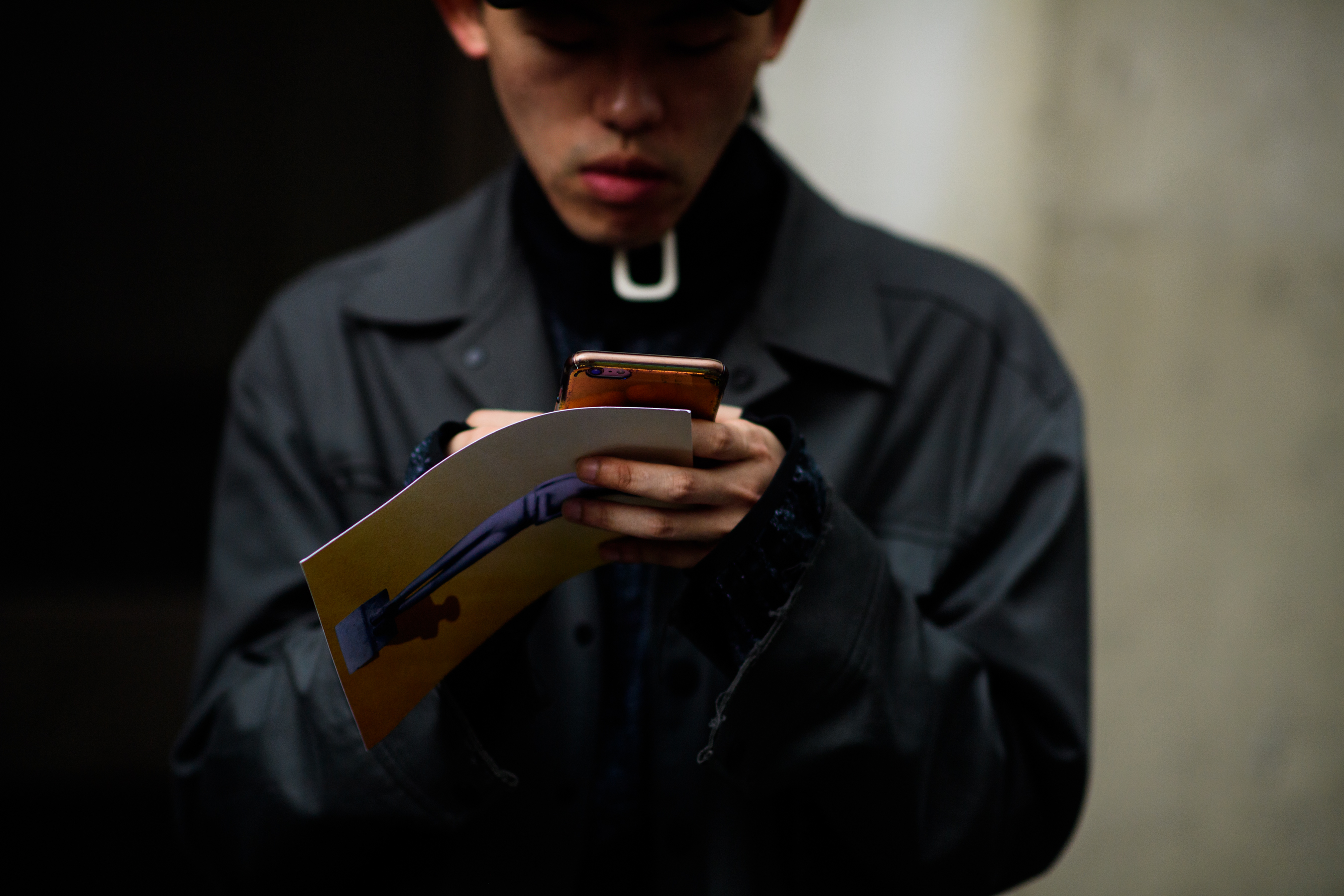A man in a dark grey raincoat