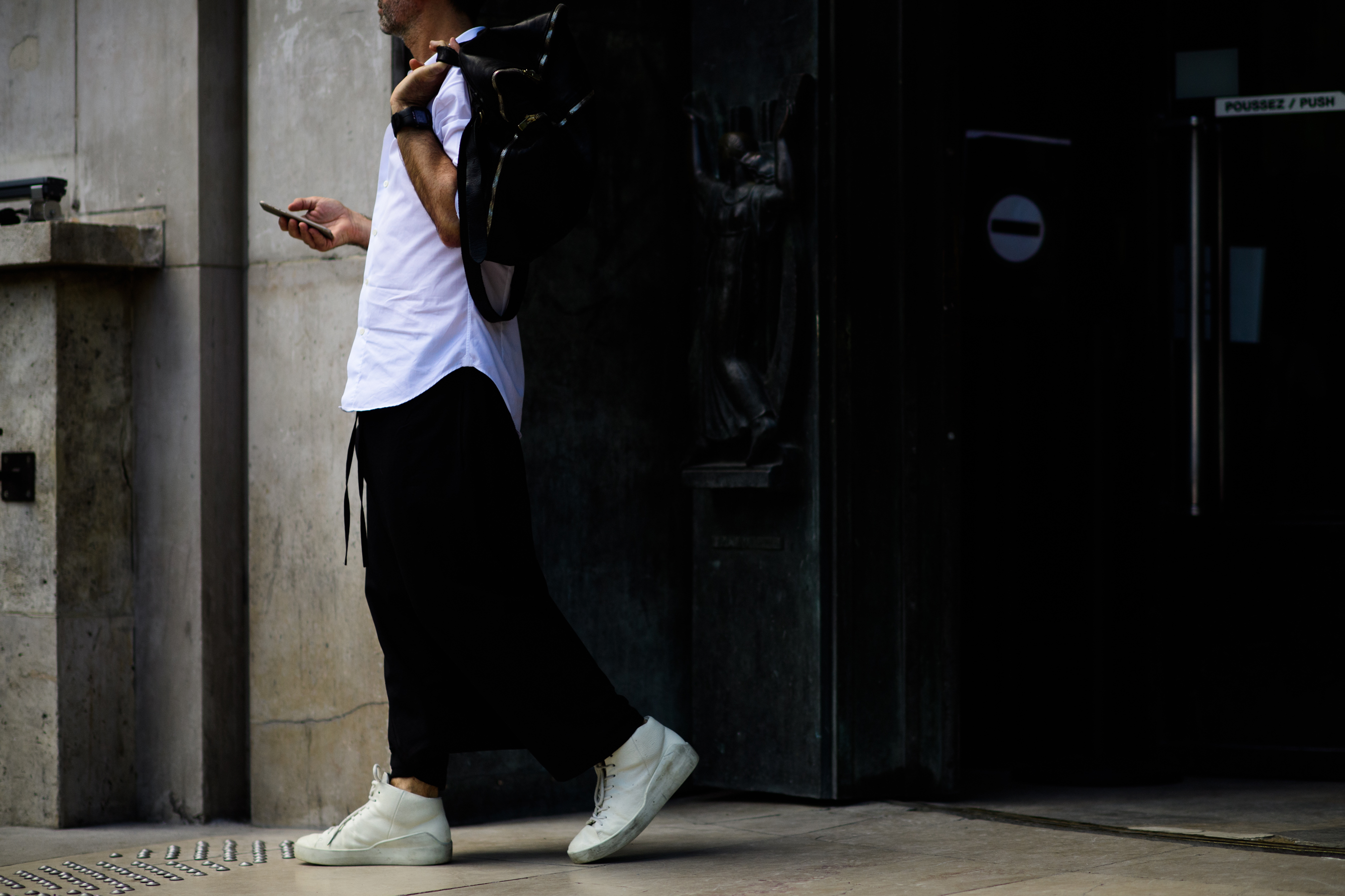 A man wearing white sneakers