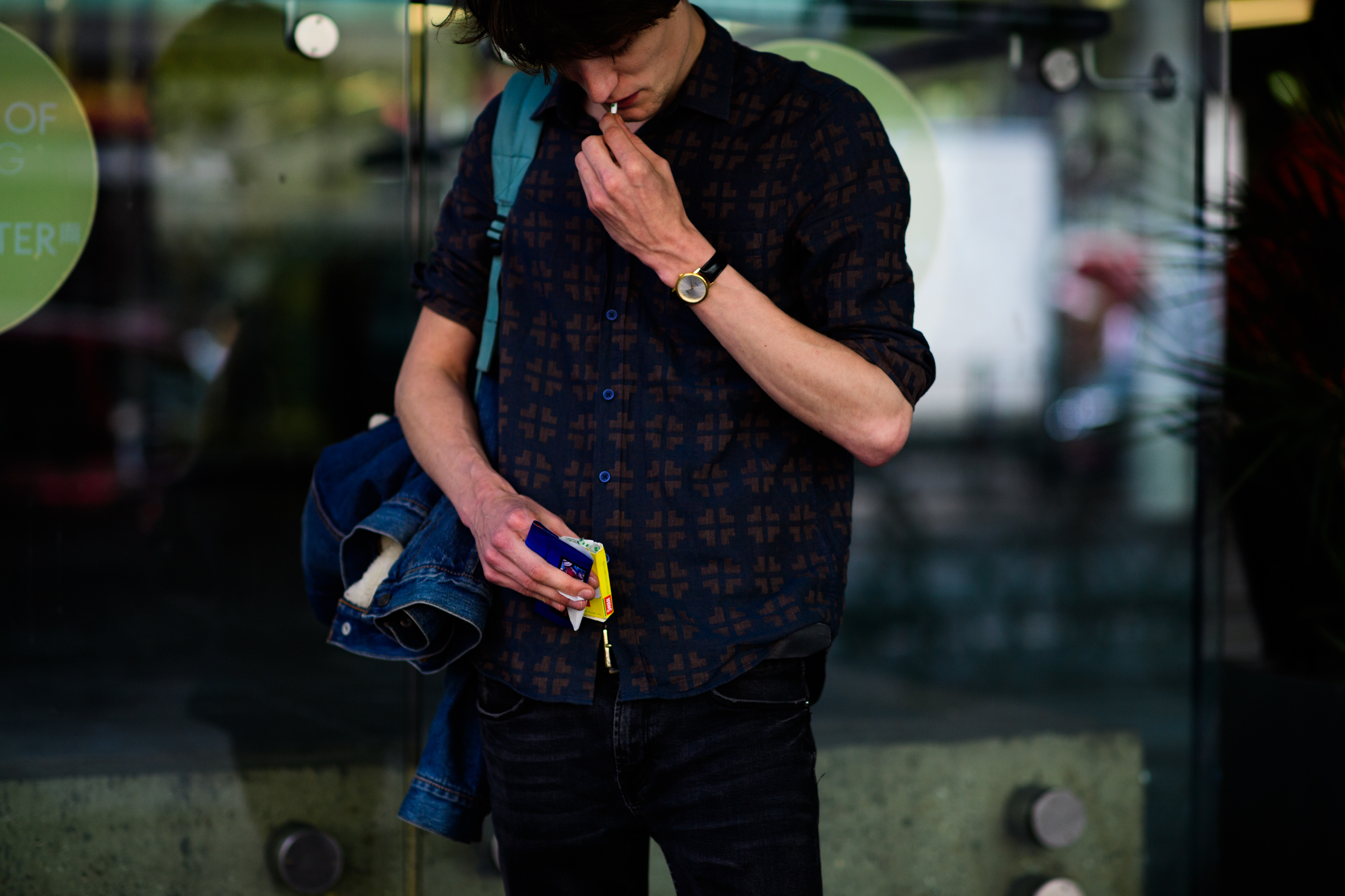 Male model smoking outside the show