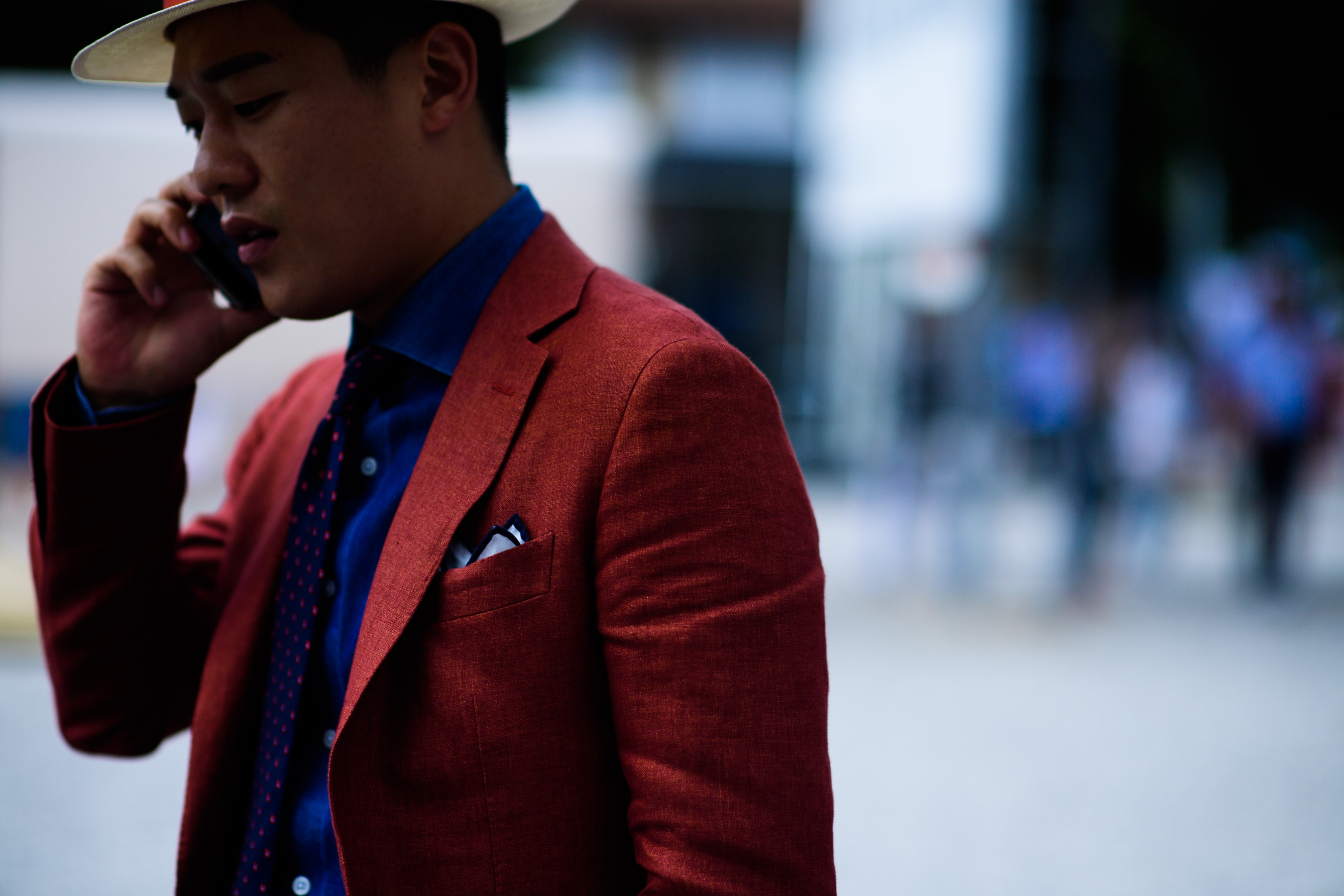 A man in a blue shirt, red jacket