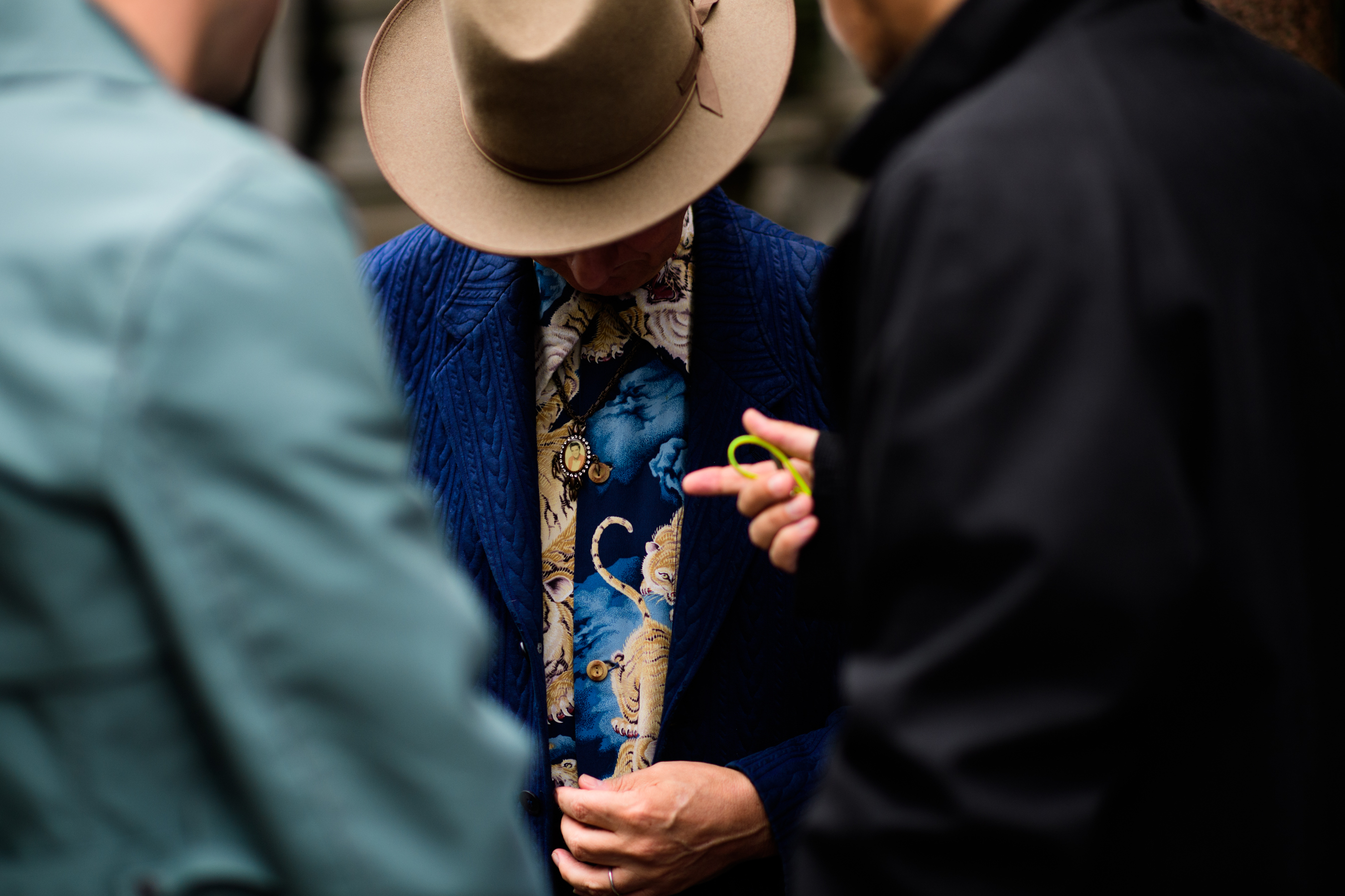 A man in a blue jacket, beige hat