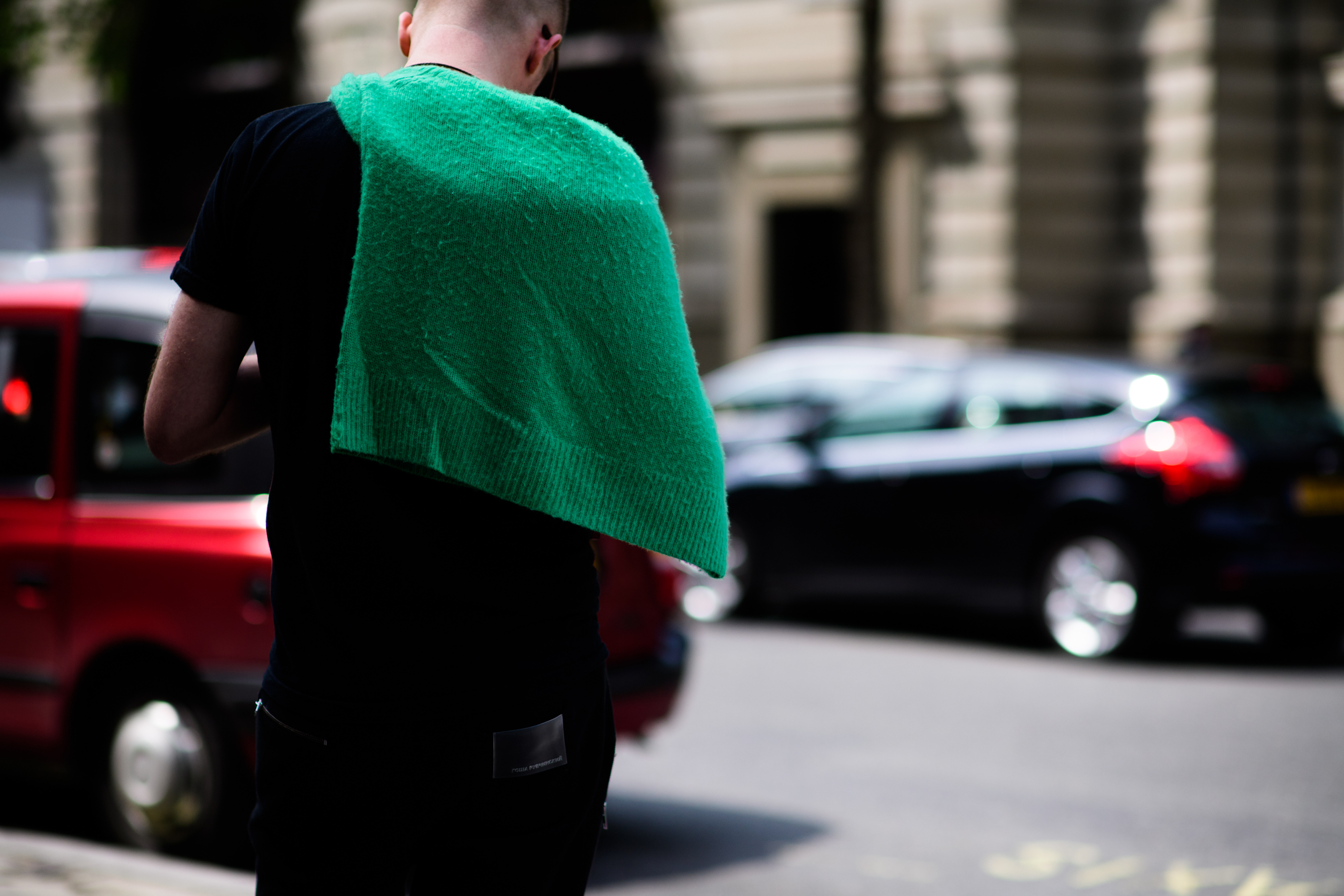 A man with a green sweater walking