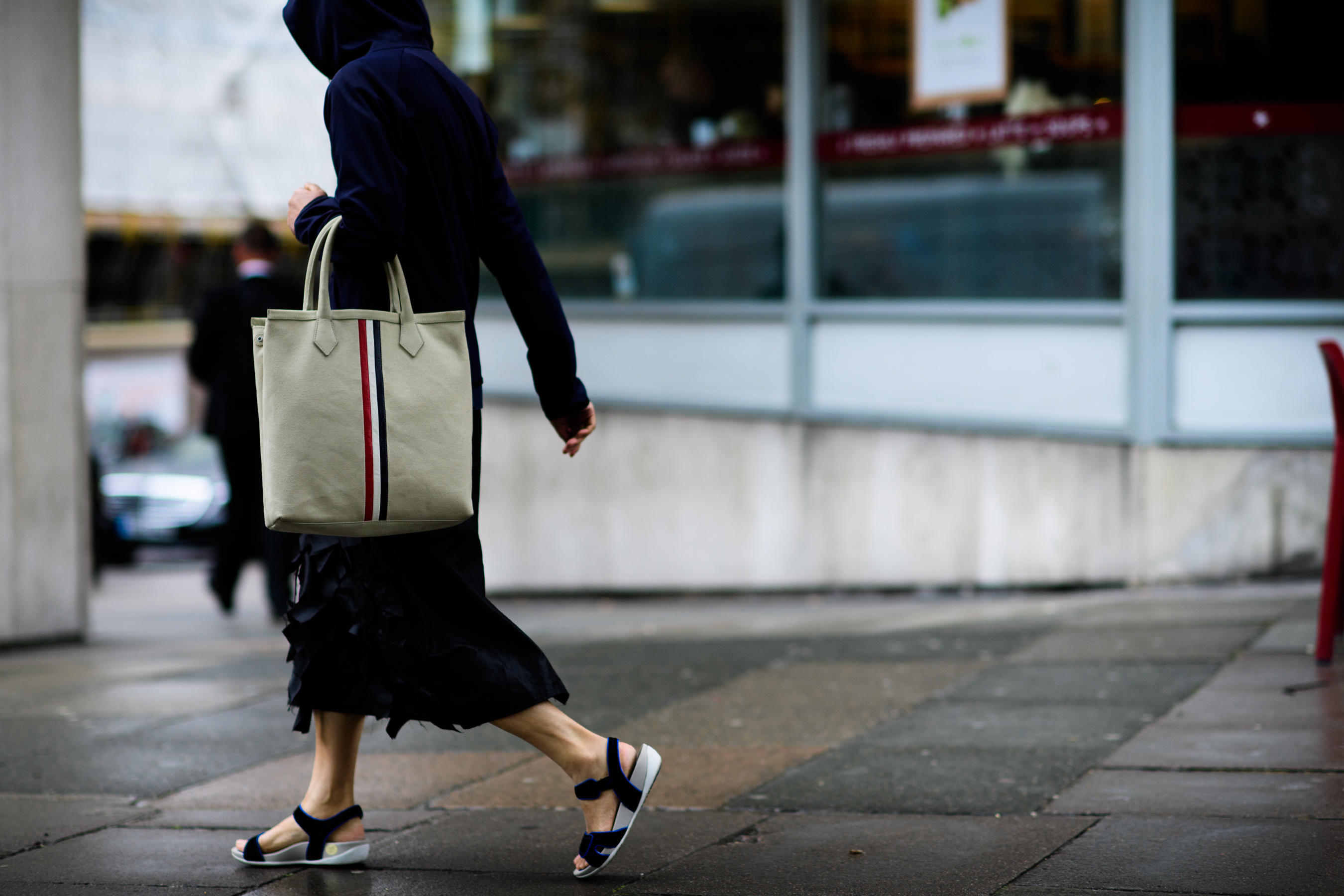 A girl with a big bag walking
