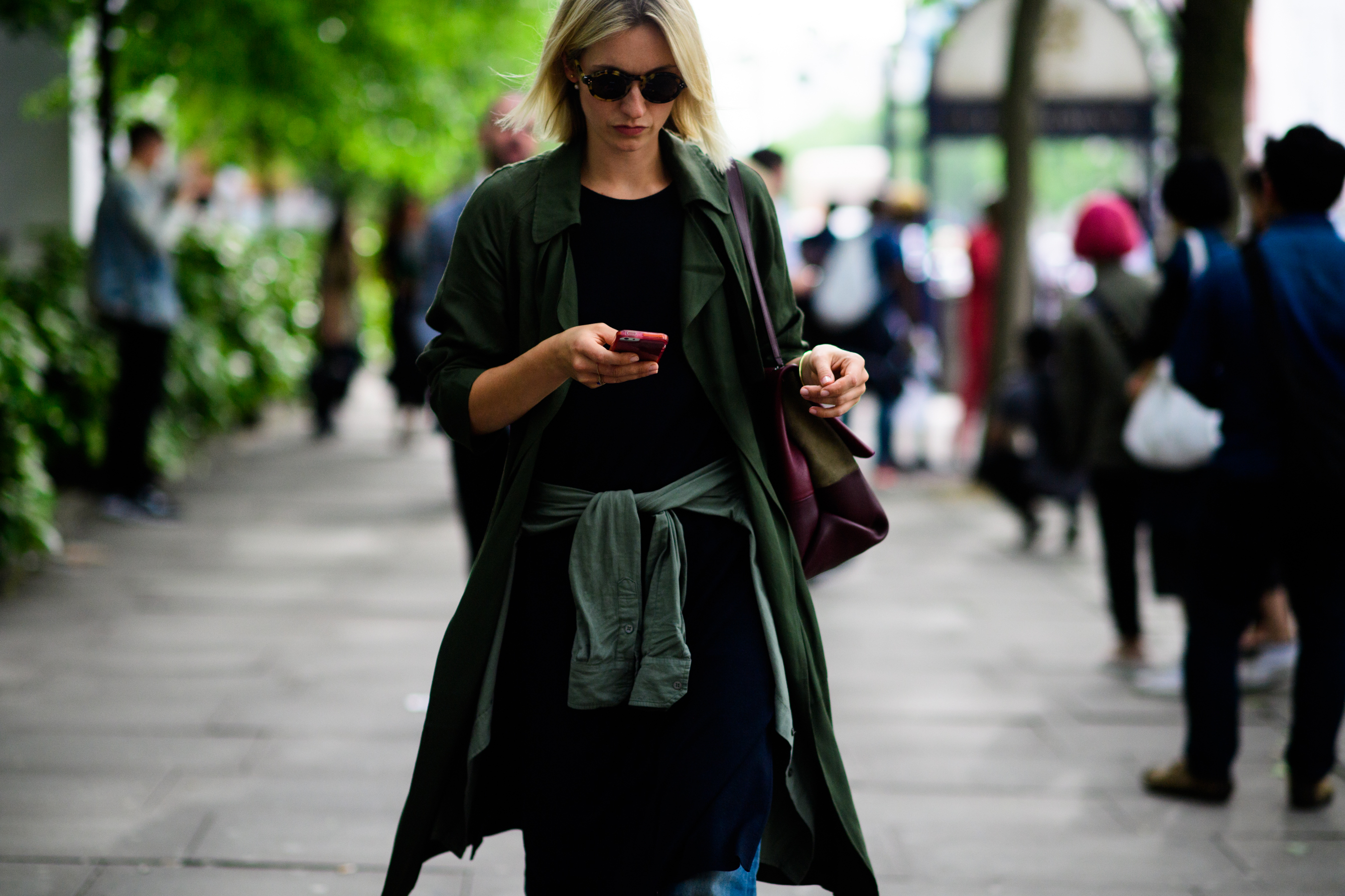 Young woman in a haki trench