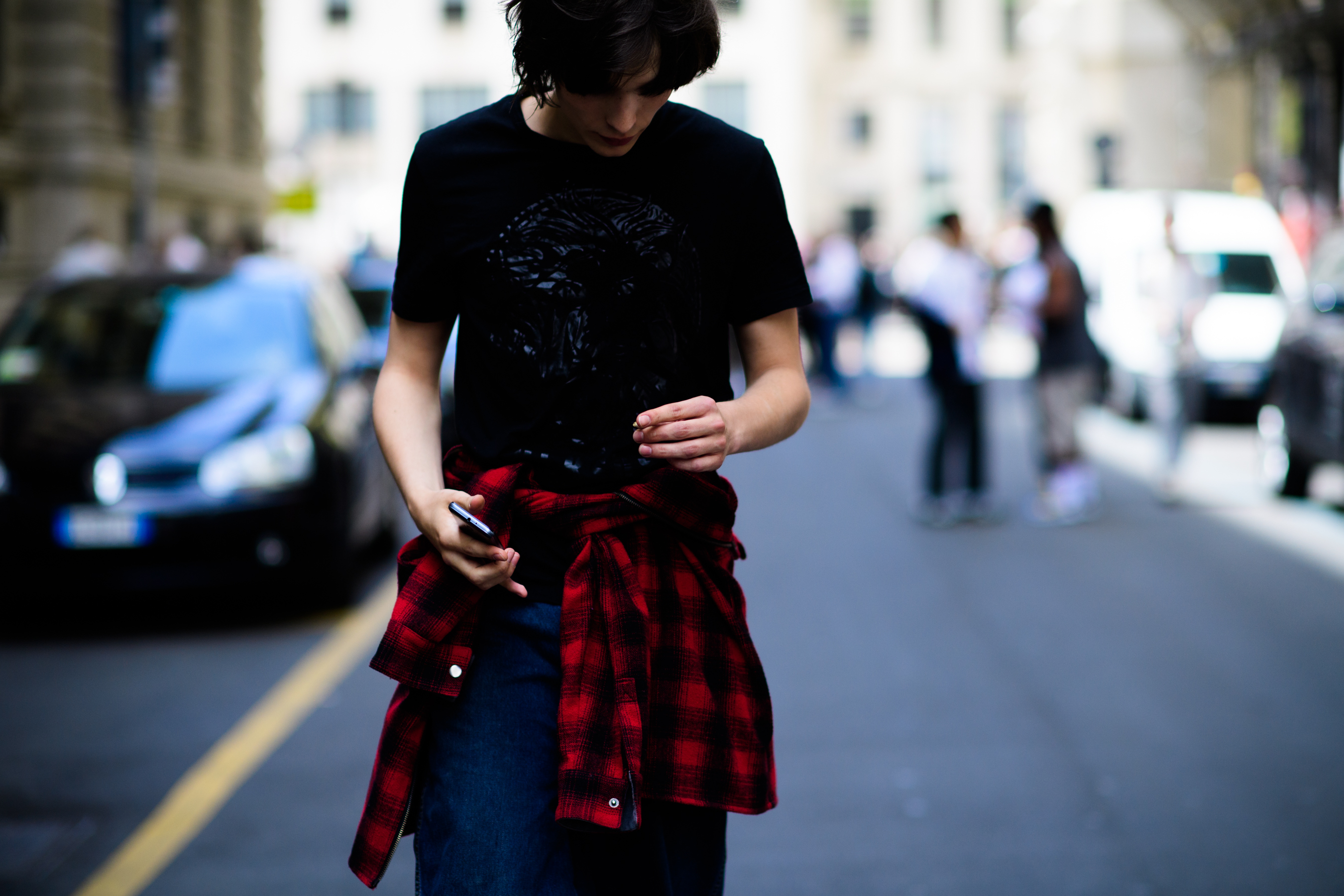 A model in a black T-Shirt and a checkered shirt