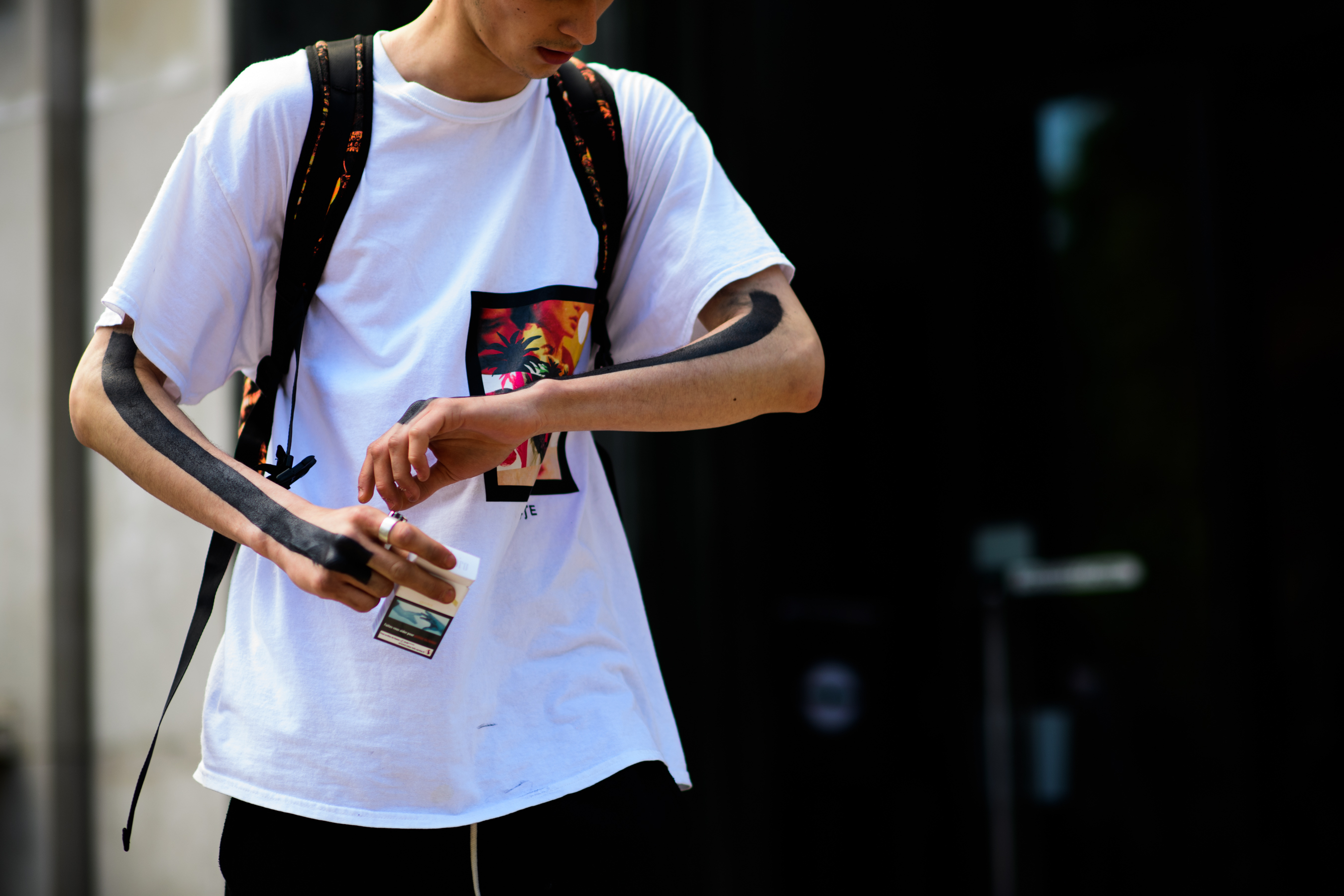 A man in a white T-Shirt with a print