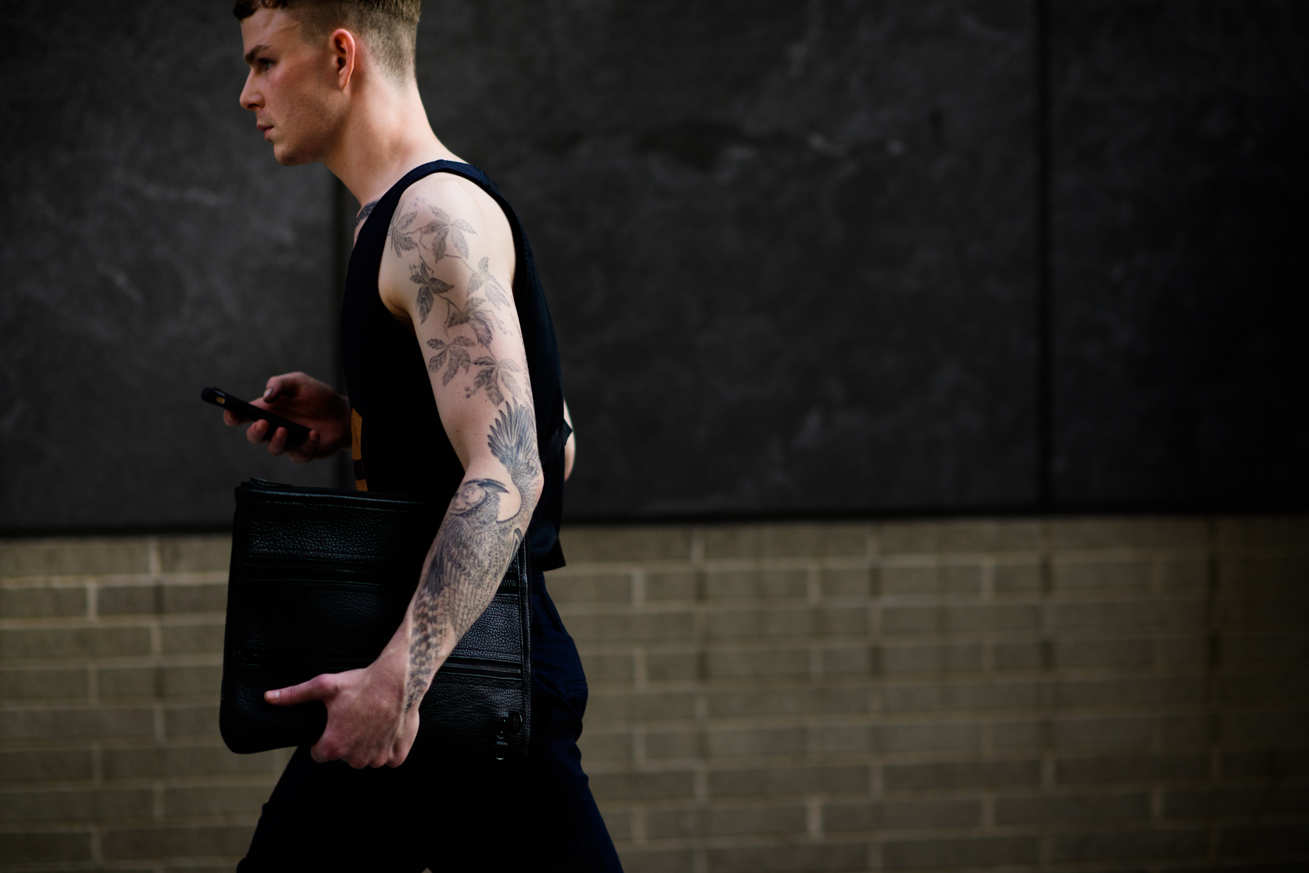 Man with tattooed arms after show