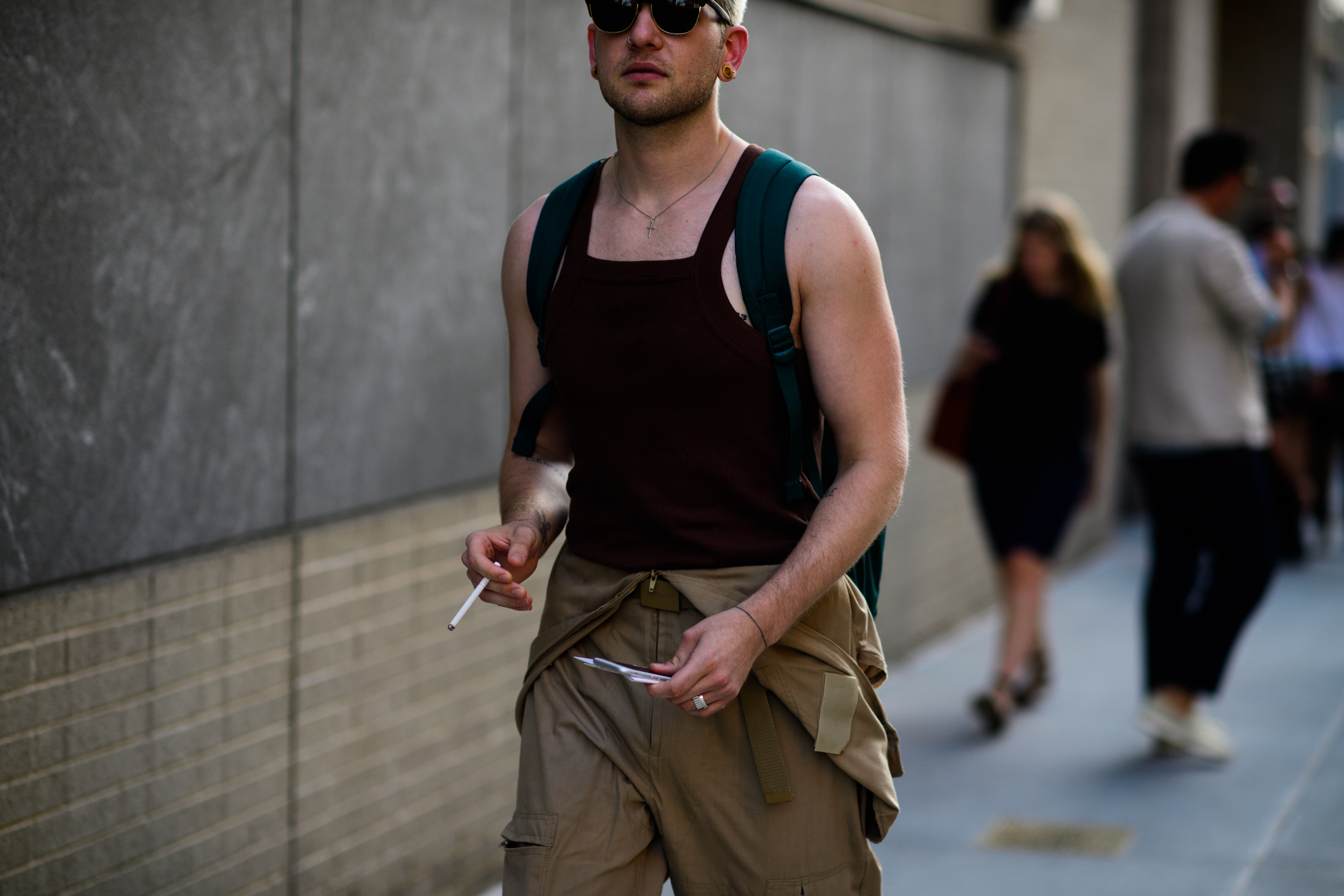Man wearing tank top and jumpsuit