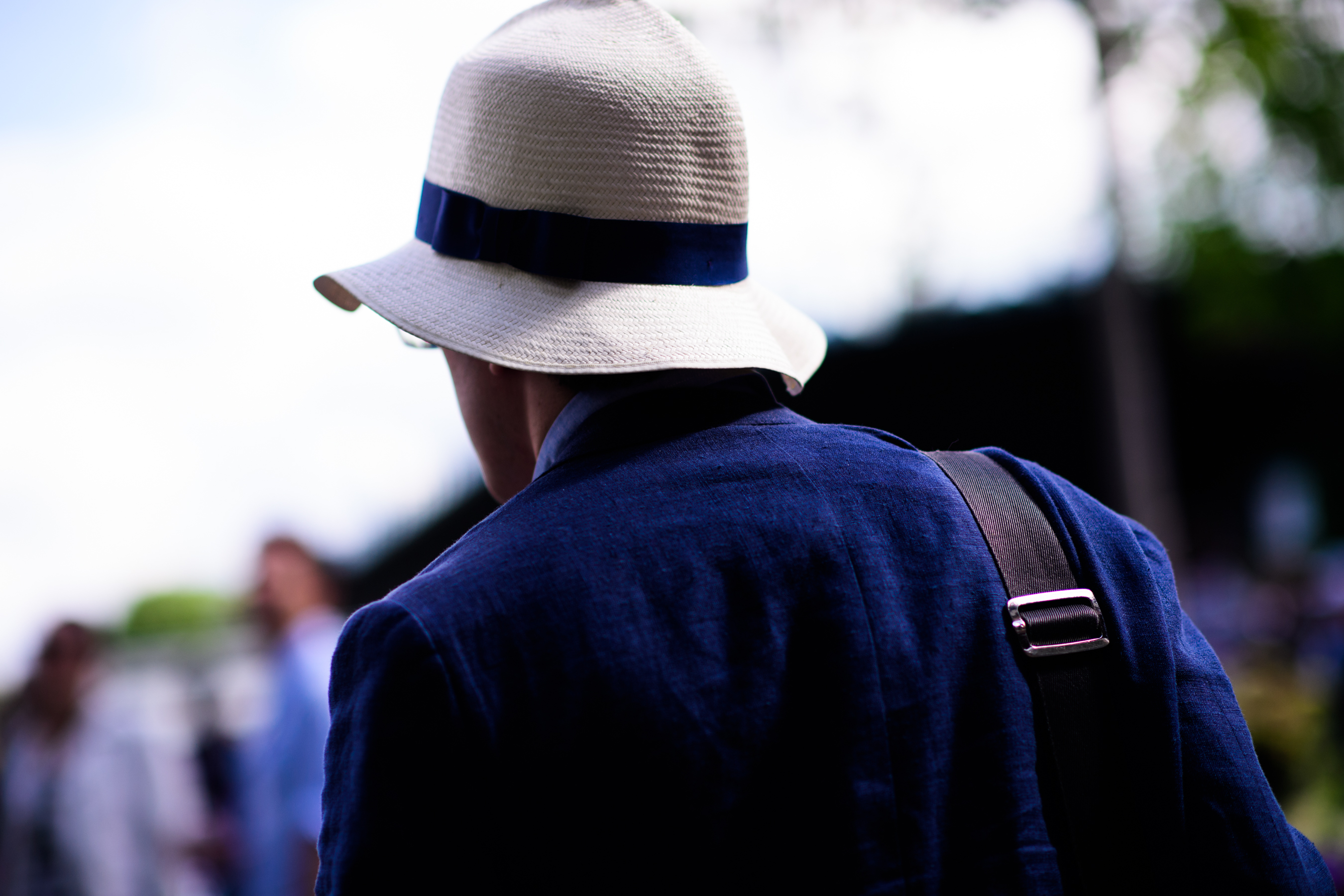 Man wearing white hat blue detail