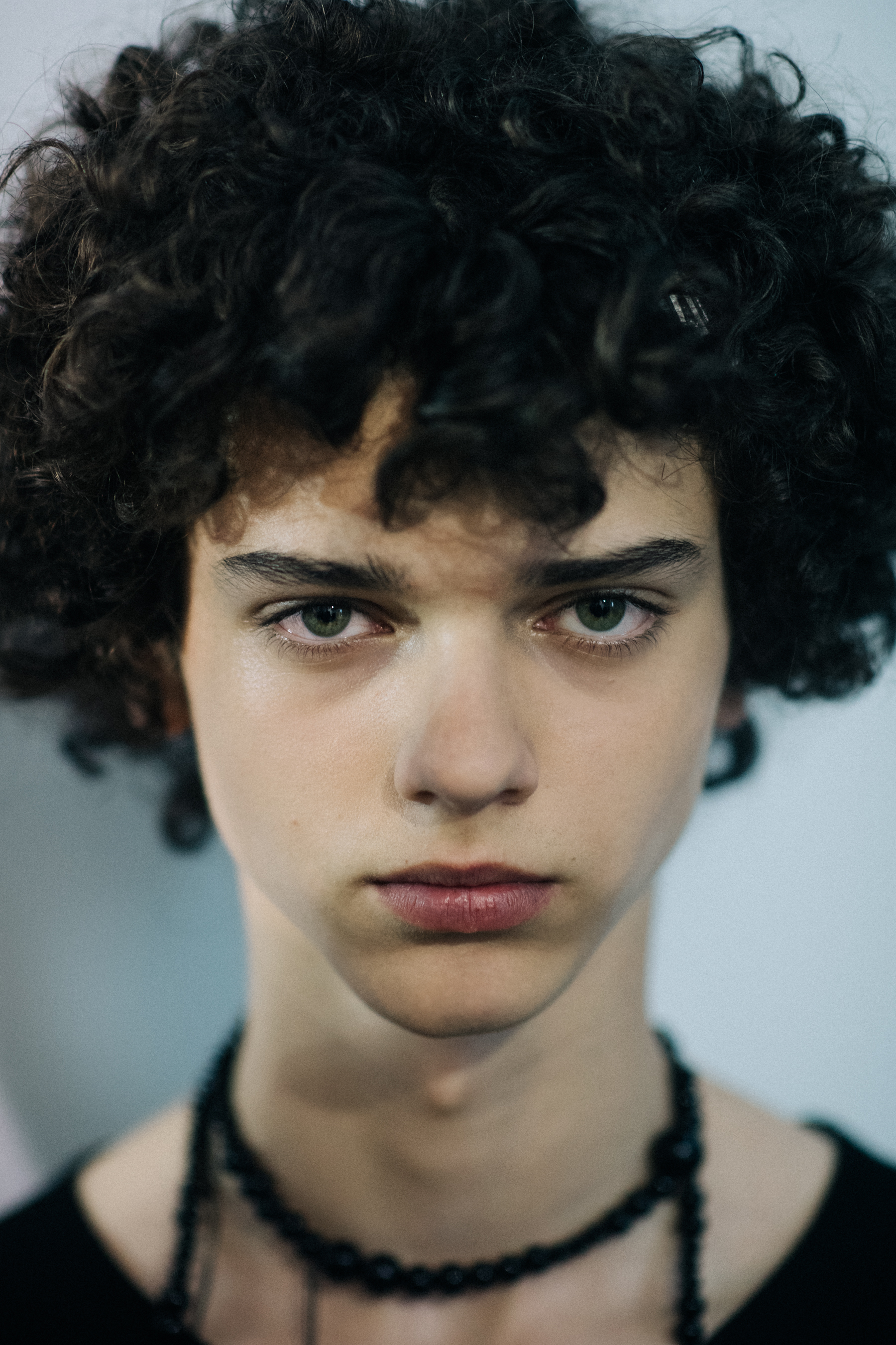 Curly-haired male model portrait
