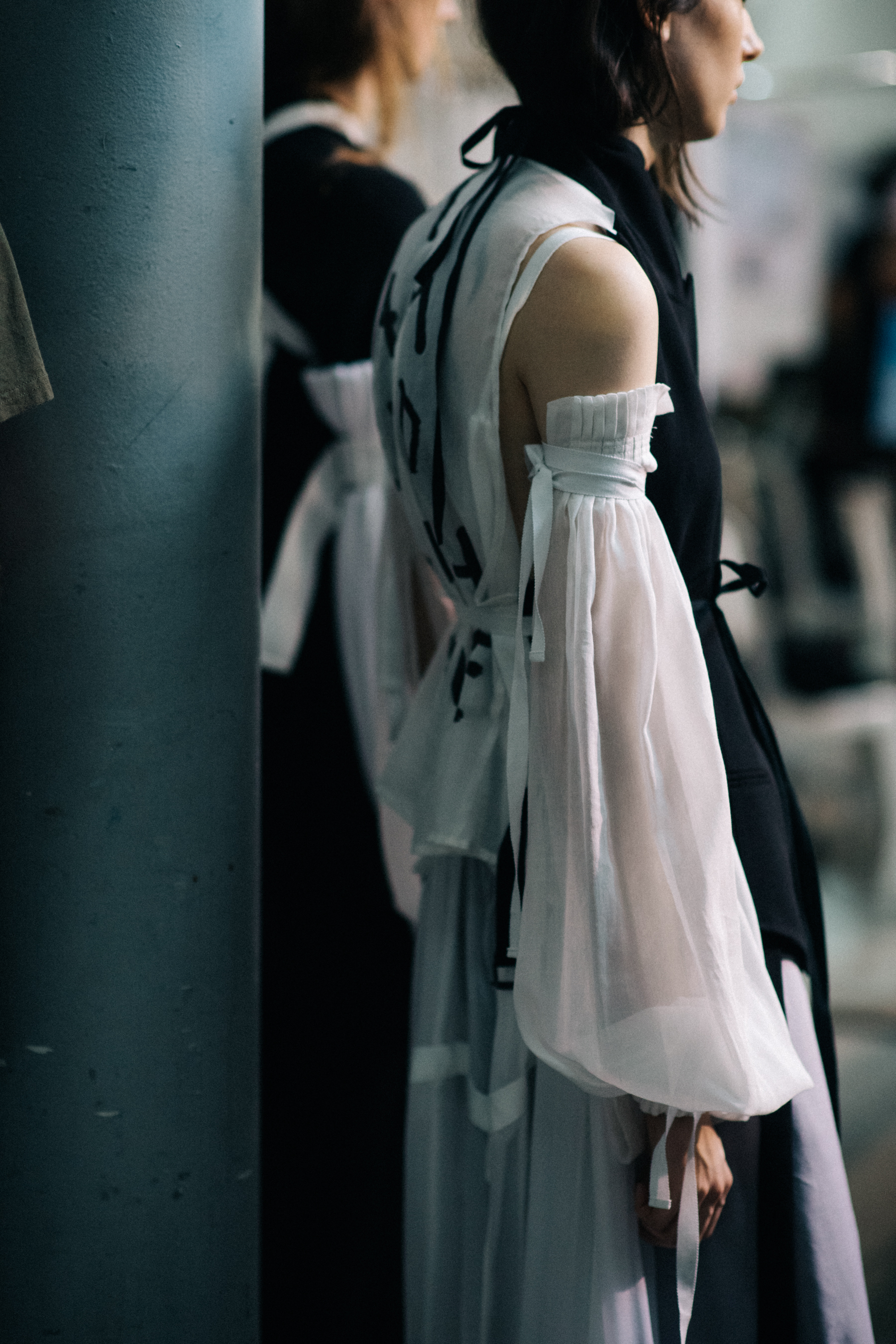 Female model wearing white blouse