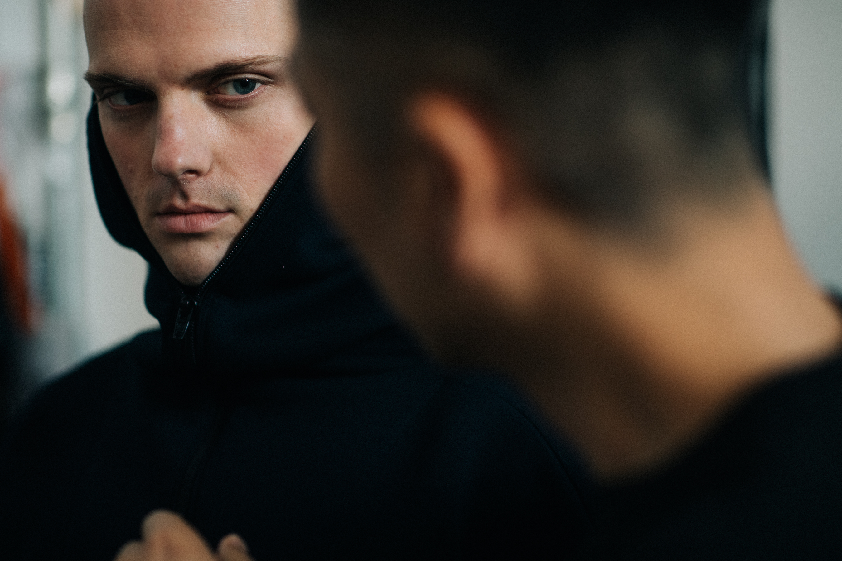 Male model wearing black hood