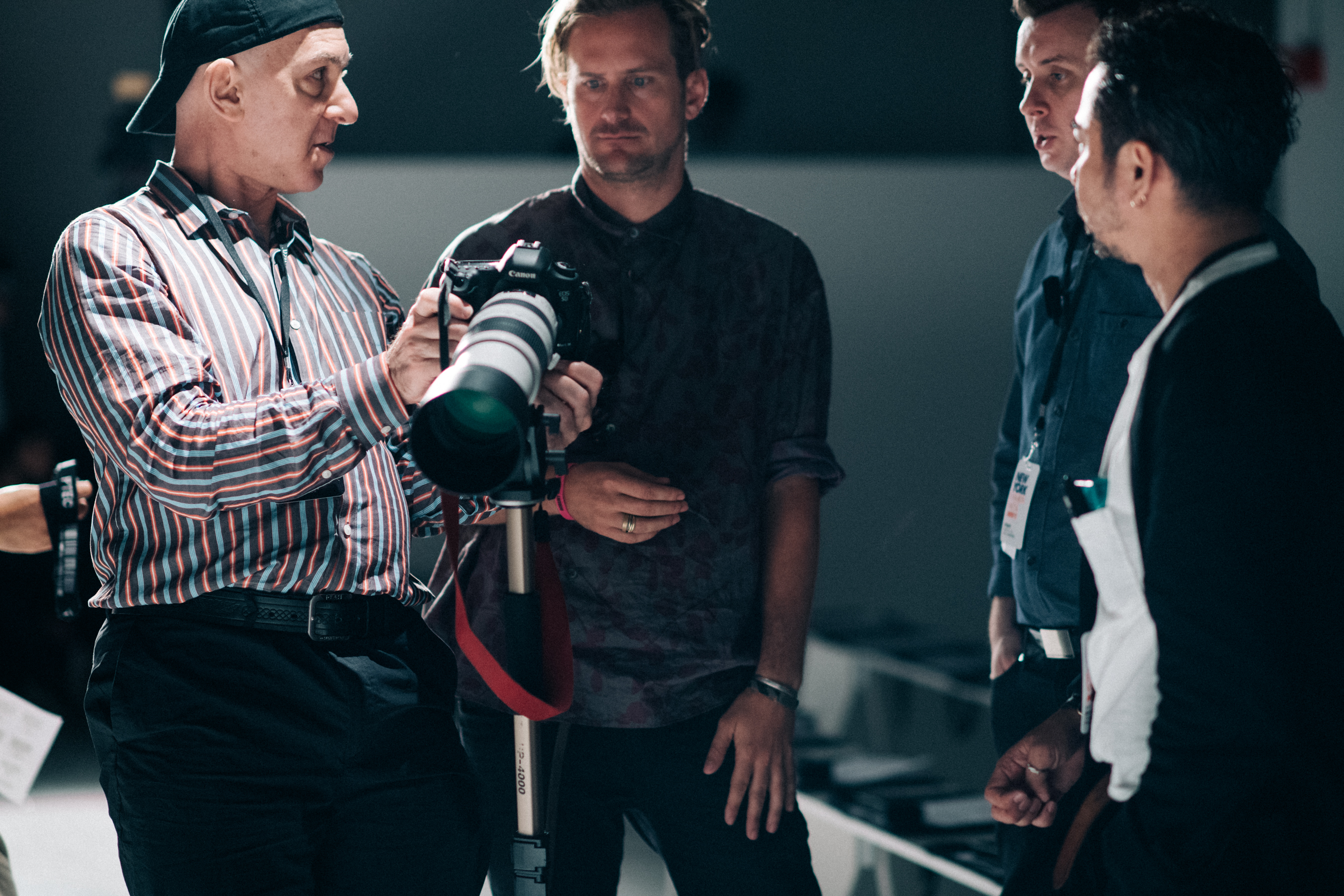 Designer talking to photographers before show