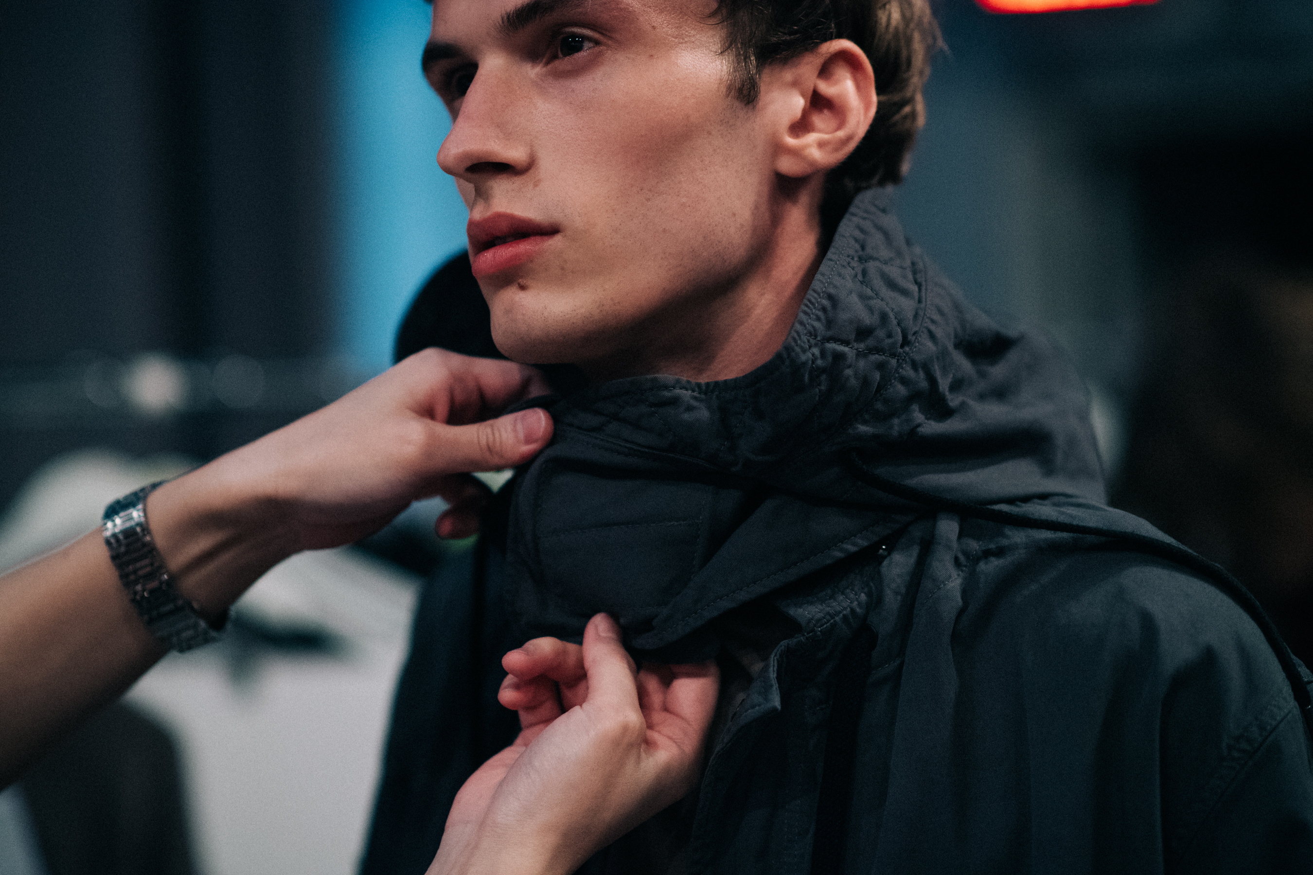 Male model getting dressed for show