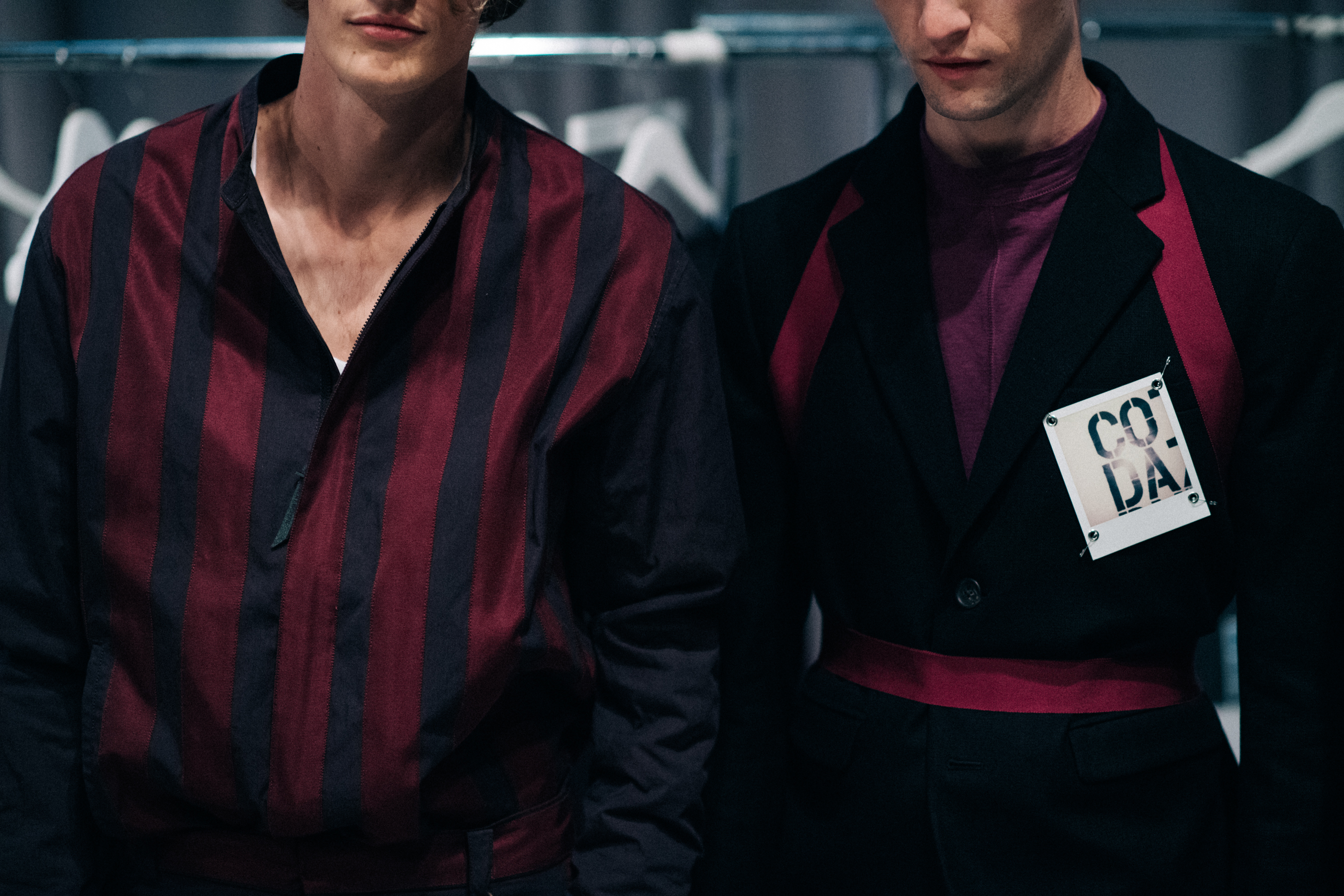 Two male models dressed in burgundy