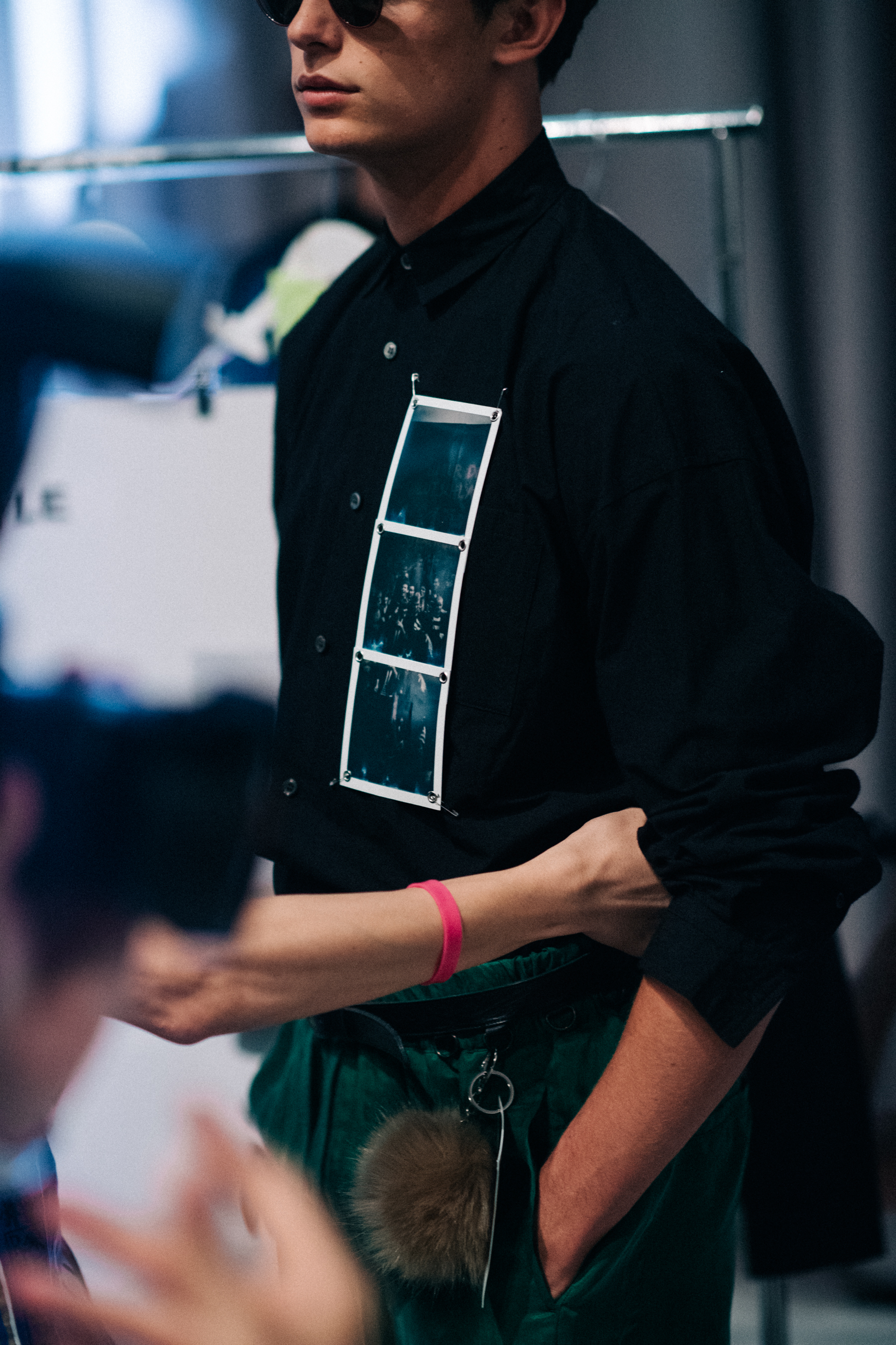 Male model wearing polaroids on shirt
