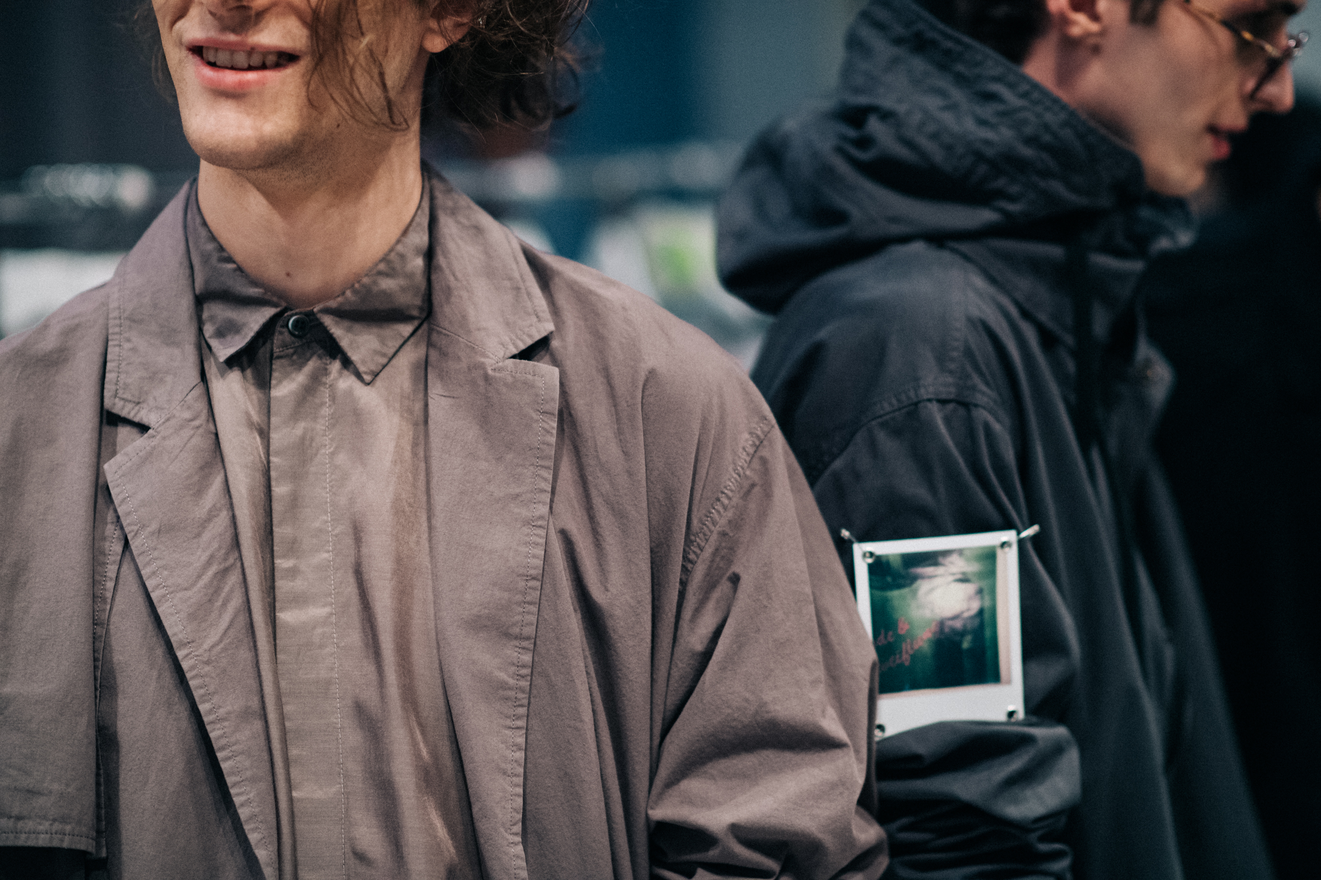 Two male models dressed before show