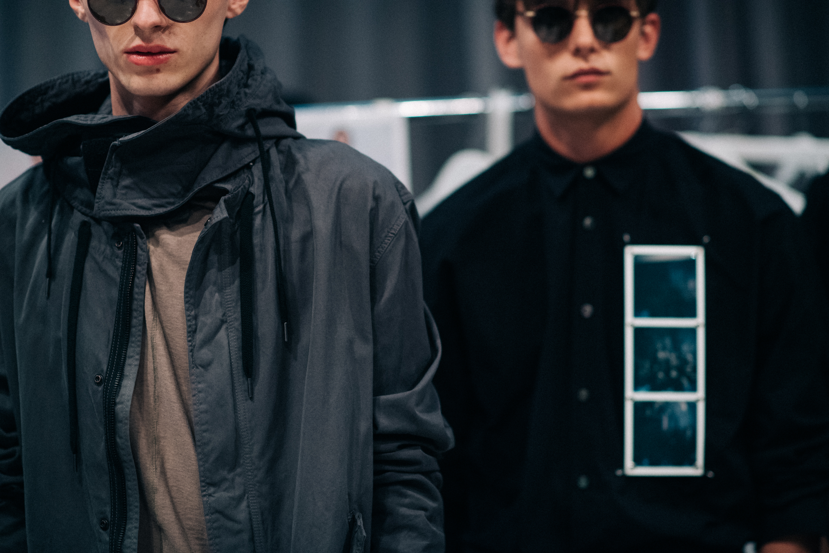 Two male models wearing dark clothes