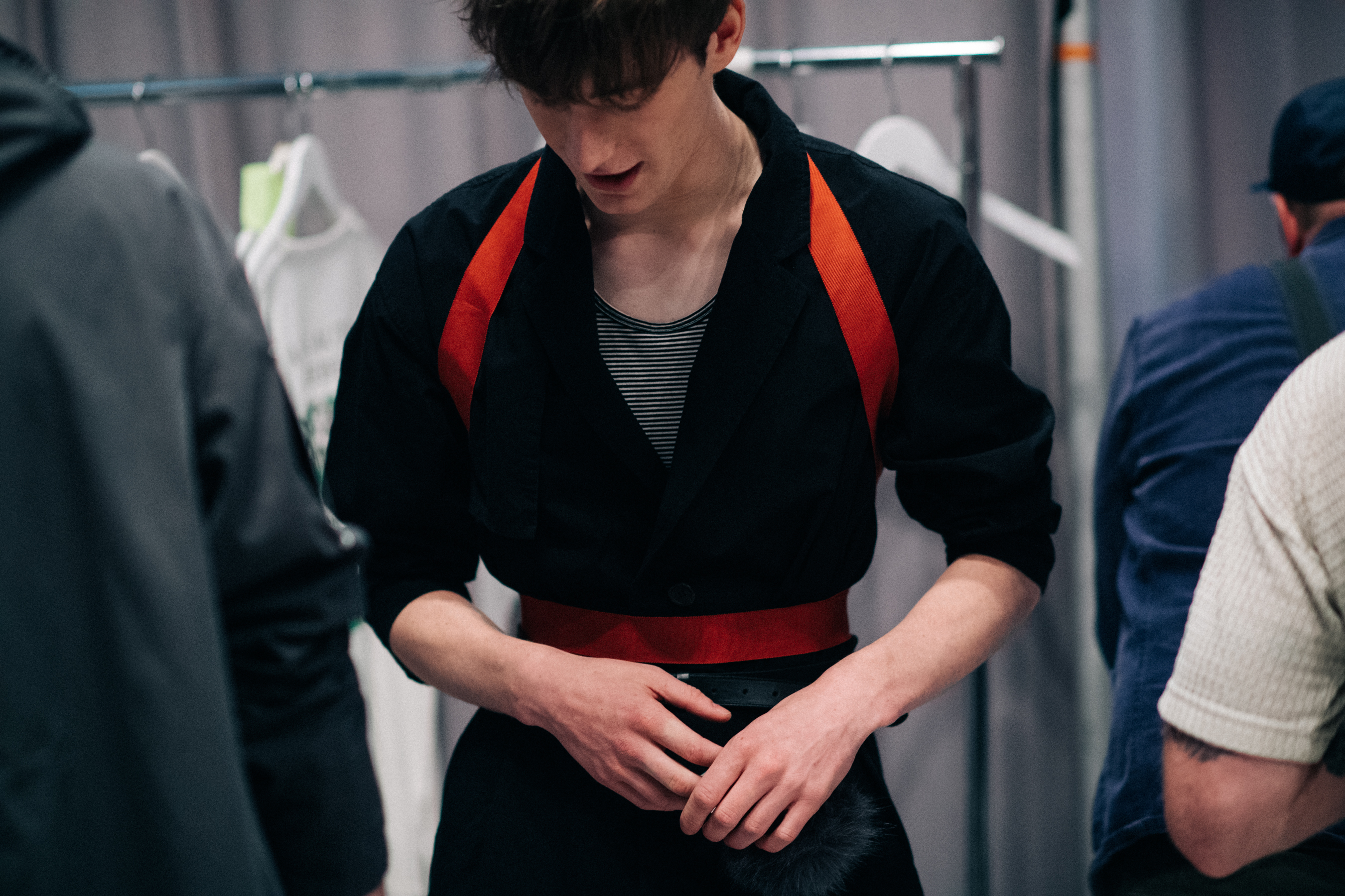 Male model wearing orange suspenders