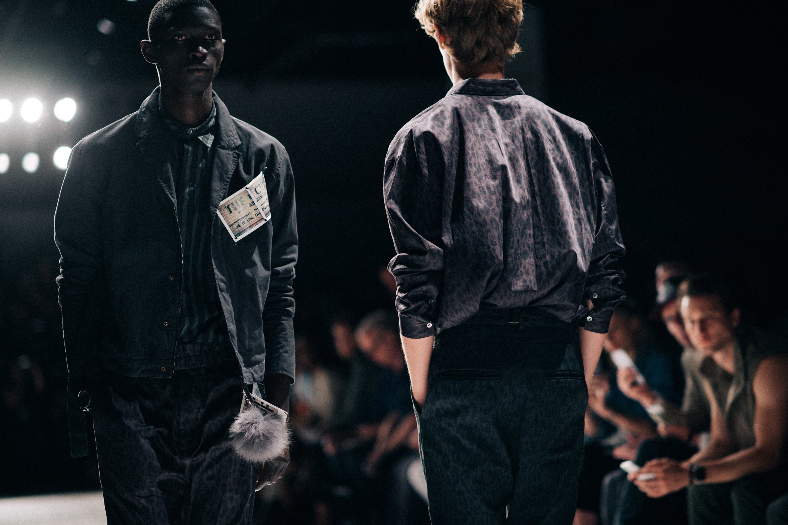 Two male models walking the runway