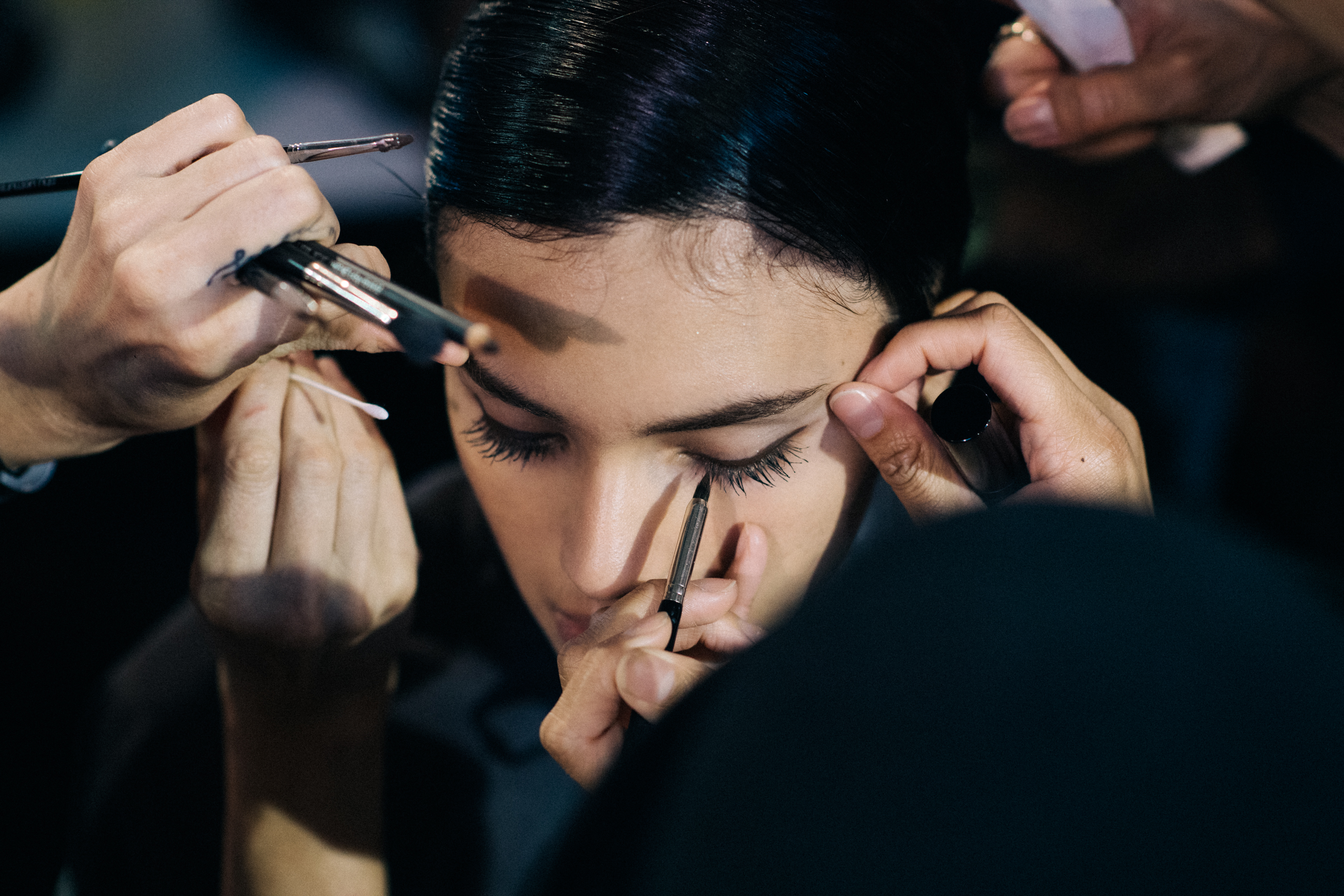 Model getting brow make up done