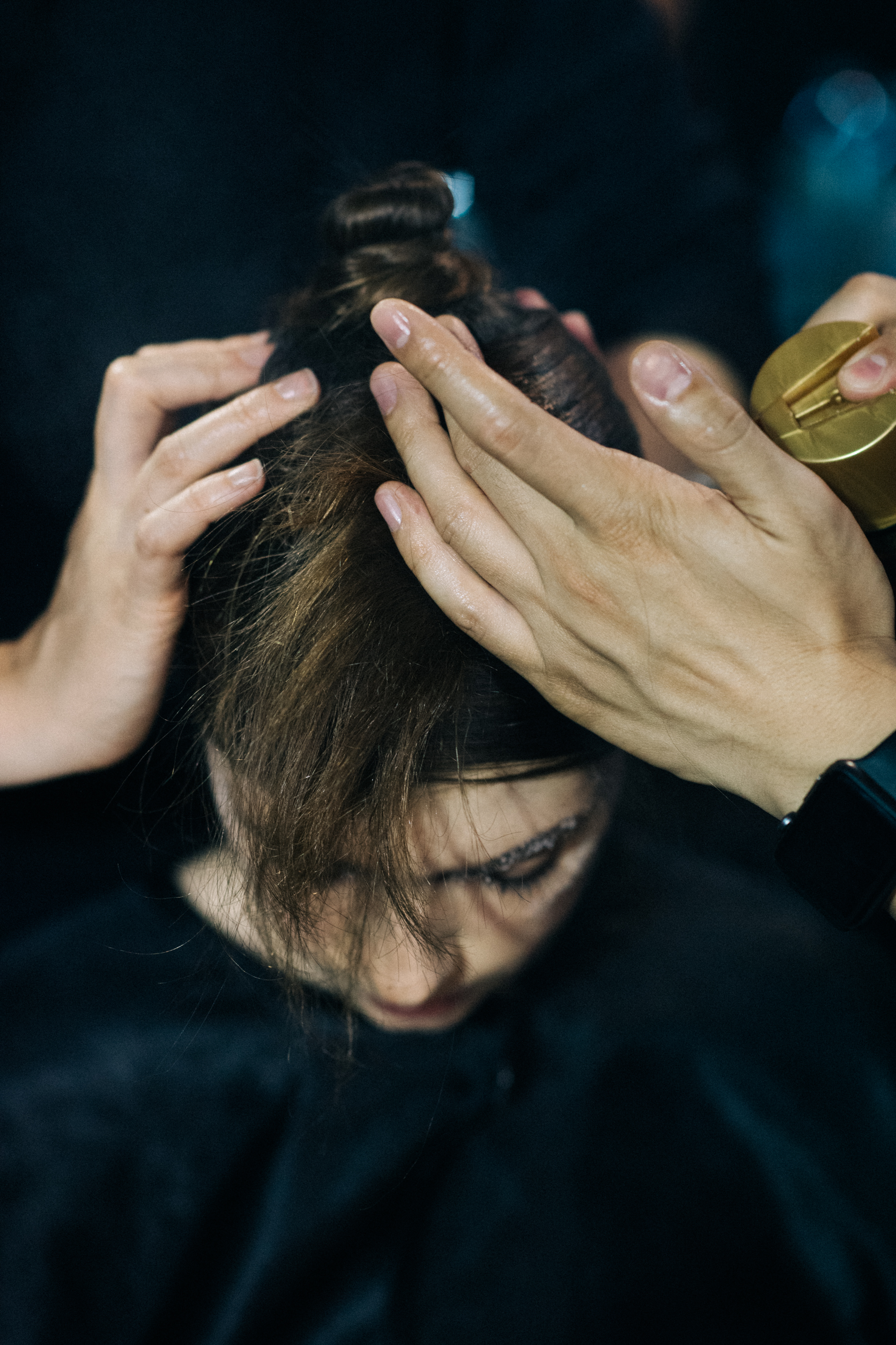 Model getting hair tied before wig