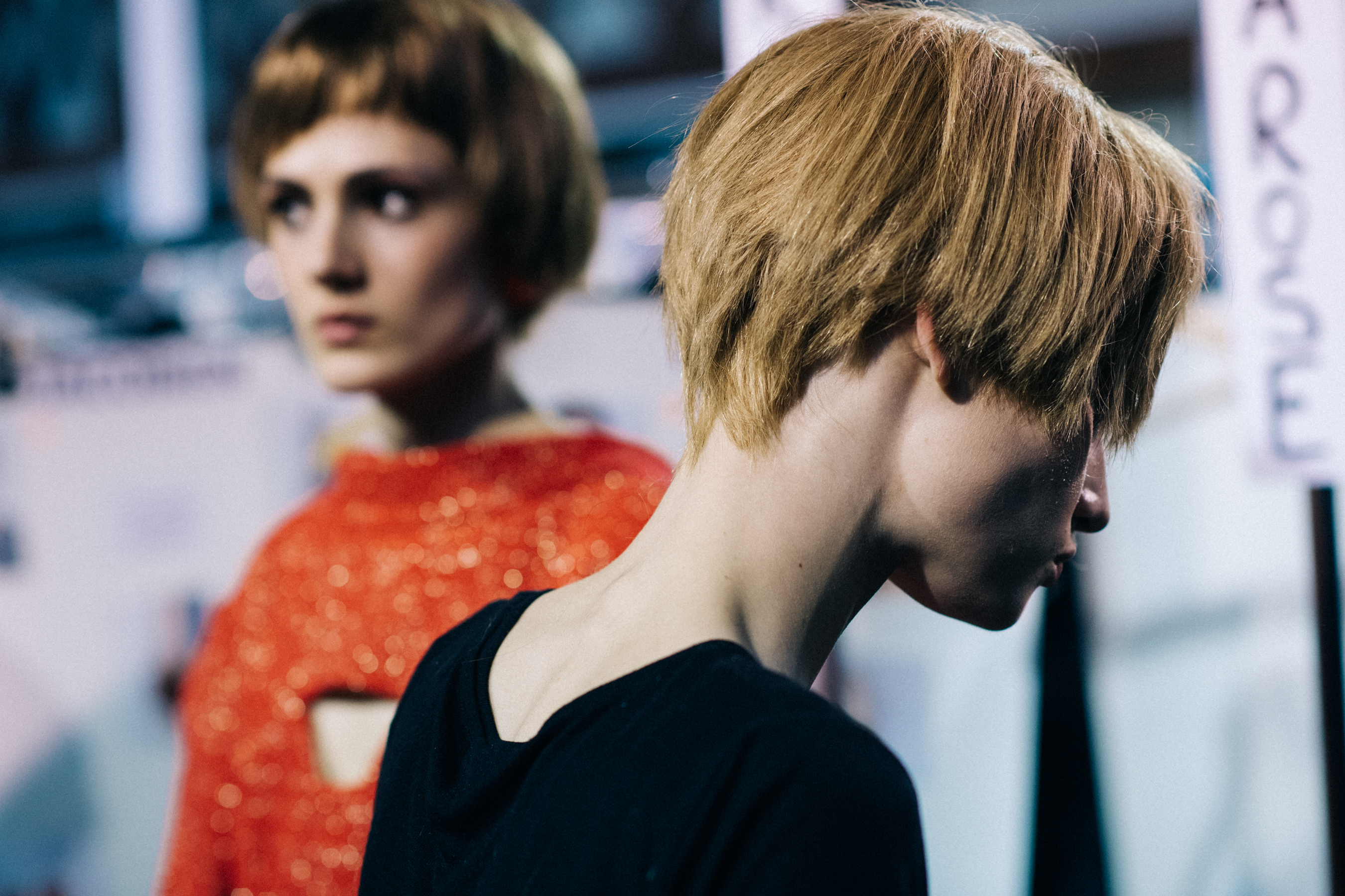 Two models wearing short wigs